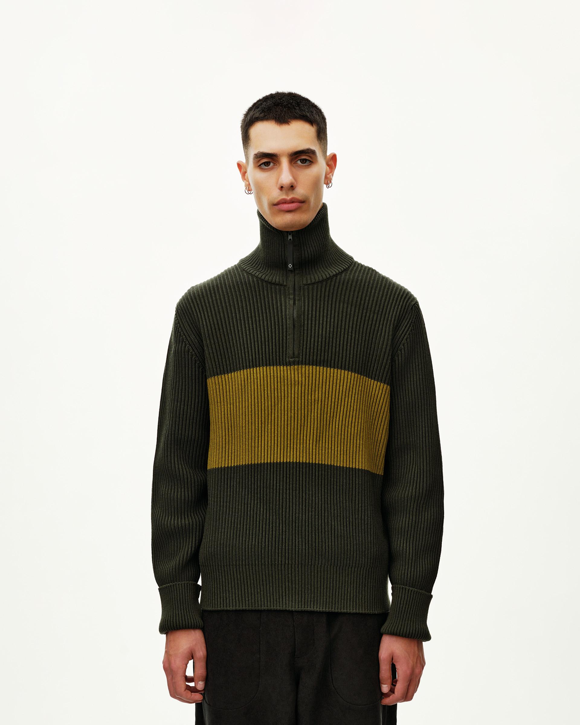 Olive Off-Race Merino Knit Half-Zip sweater on model, front view with yellow contrast chest stripe