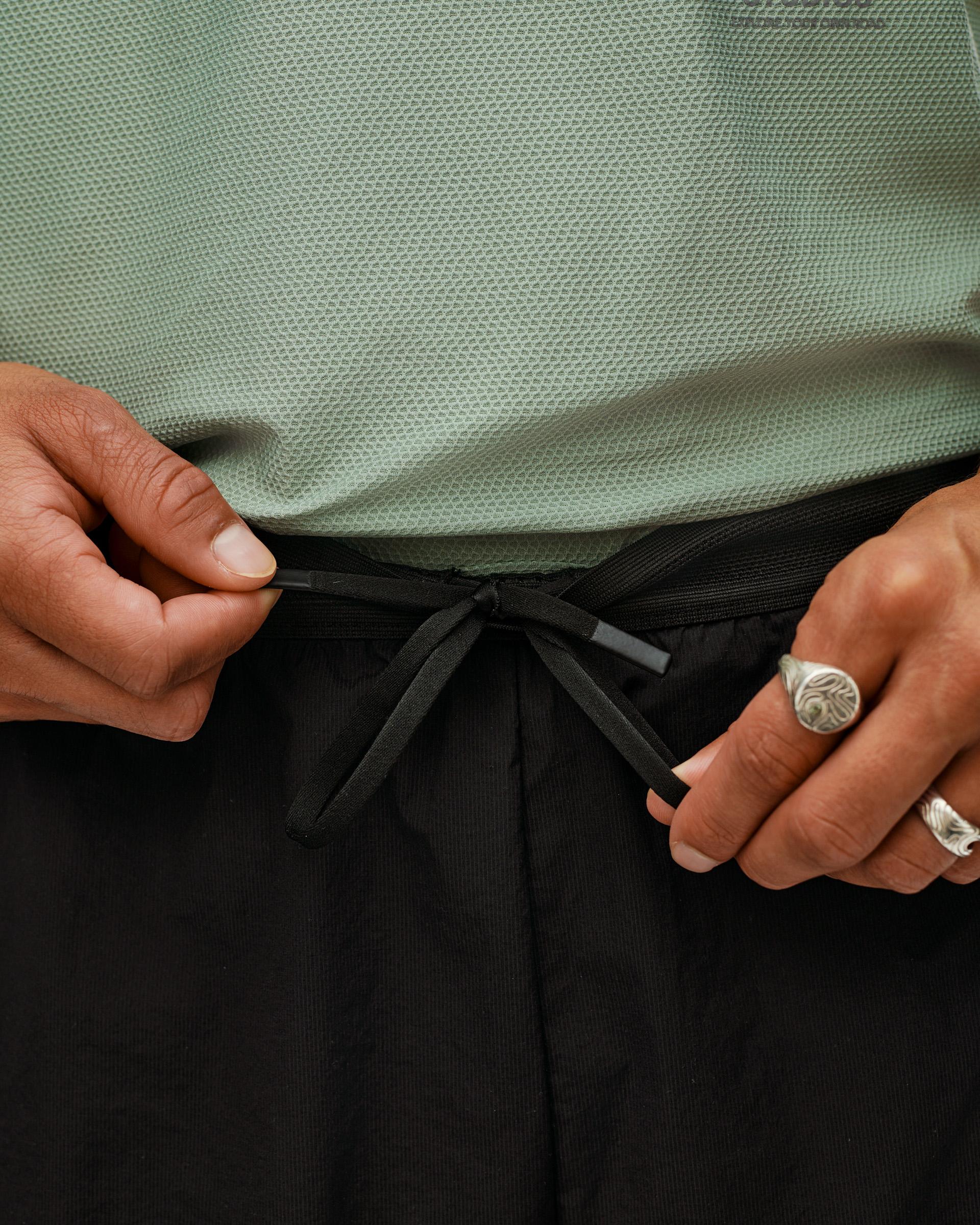 Black Balance 2-in-1 shorts, waistband detail on model showing drawstring tie