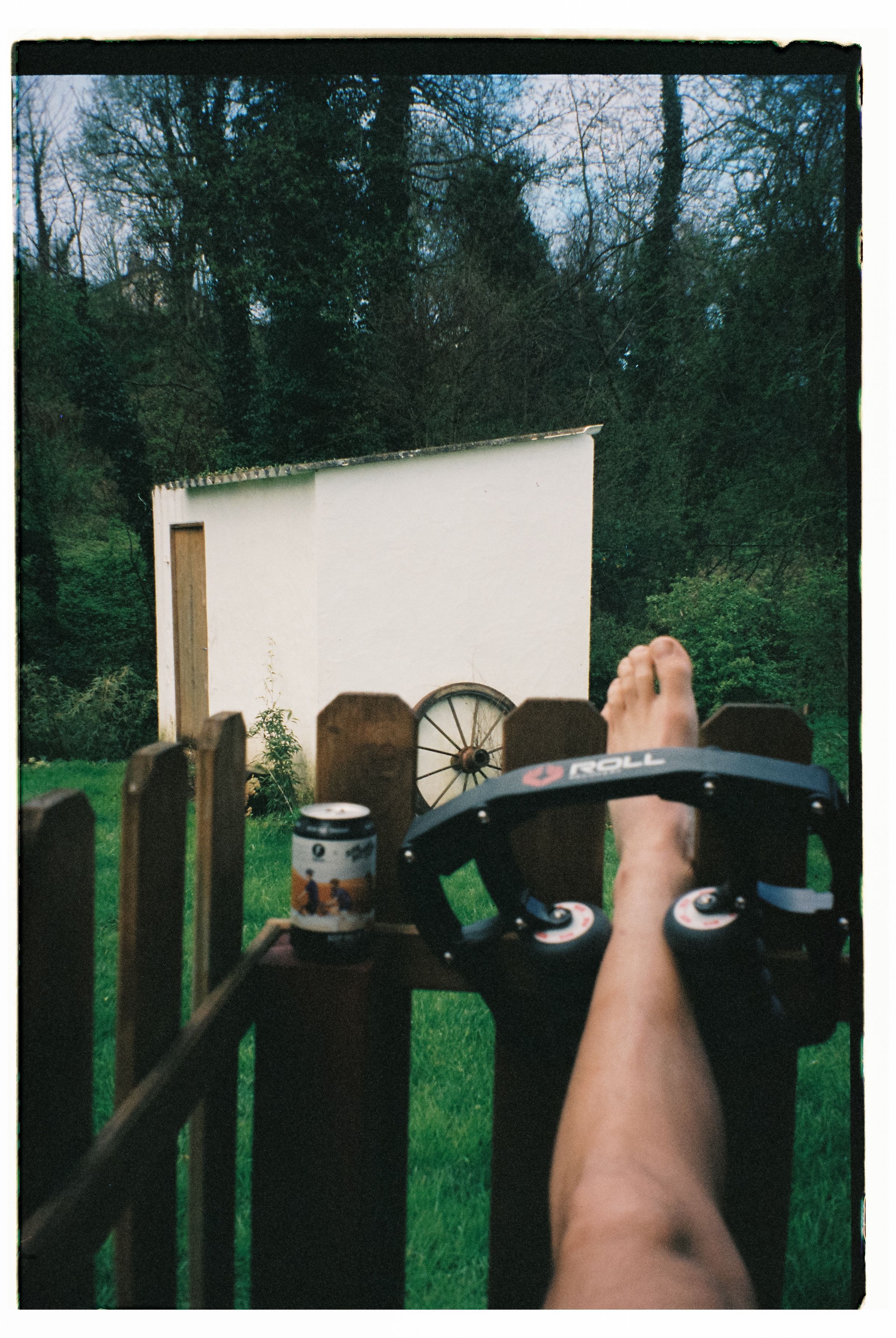 Cyclist's perspective view of handlebars and hands during rural ride past countryside building