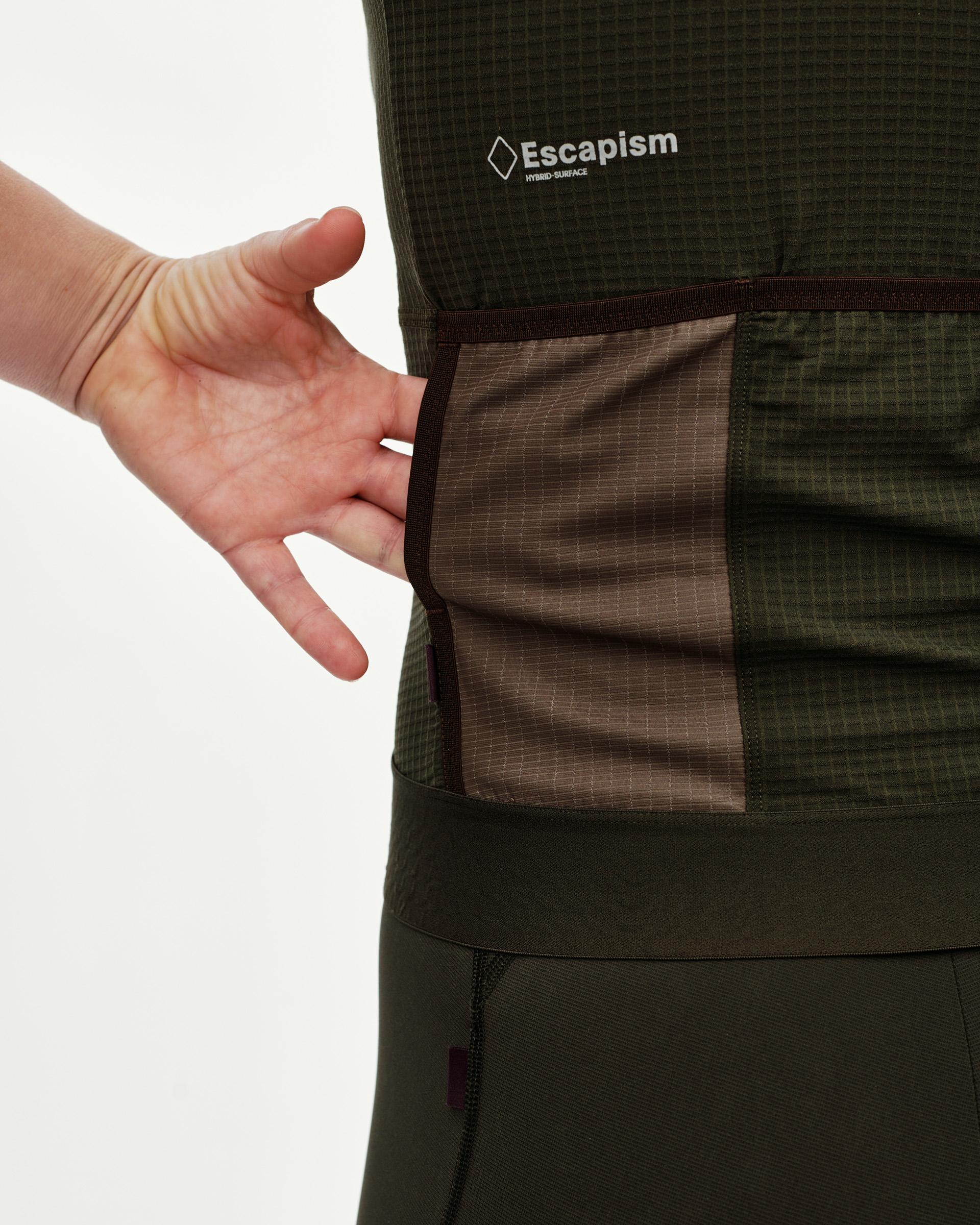 Dark Olive Escapism cycling jersey, rear detail on model showing contrast brown back pocket