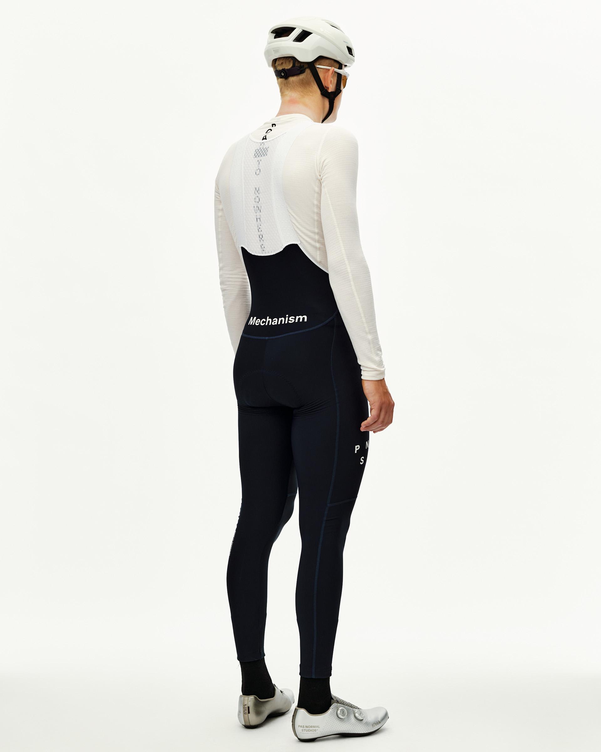 Navy Mechanism cycling thermal long bibs on model, rear view with white logo waistband print
