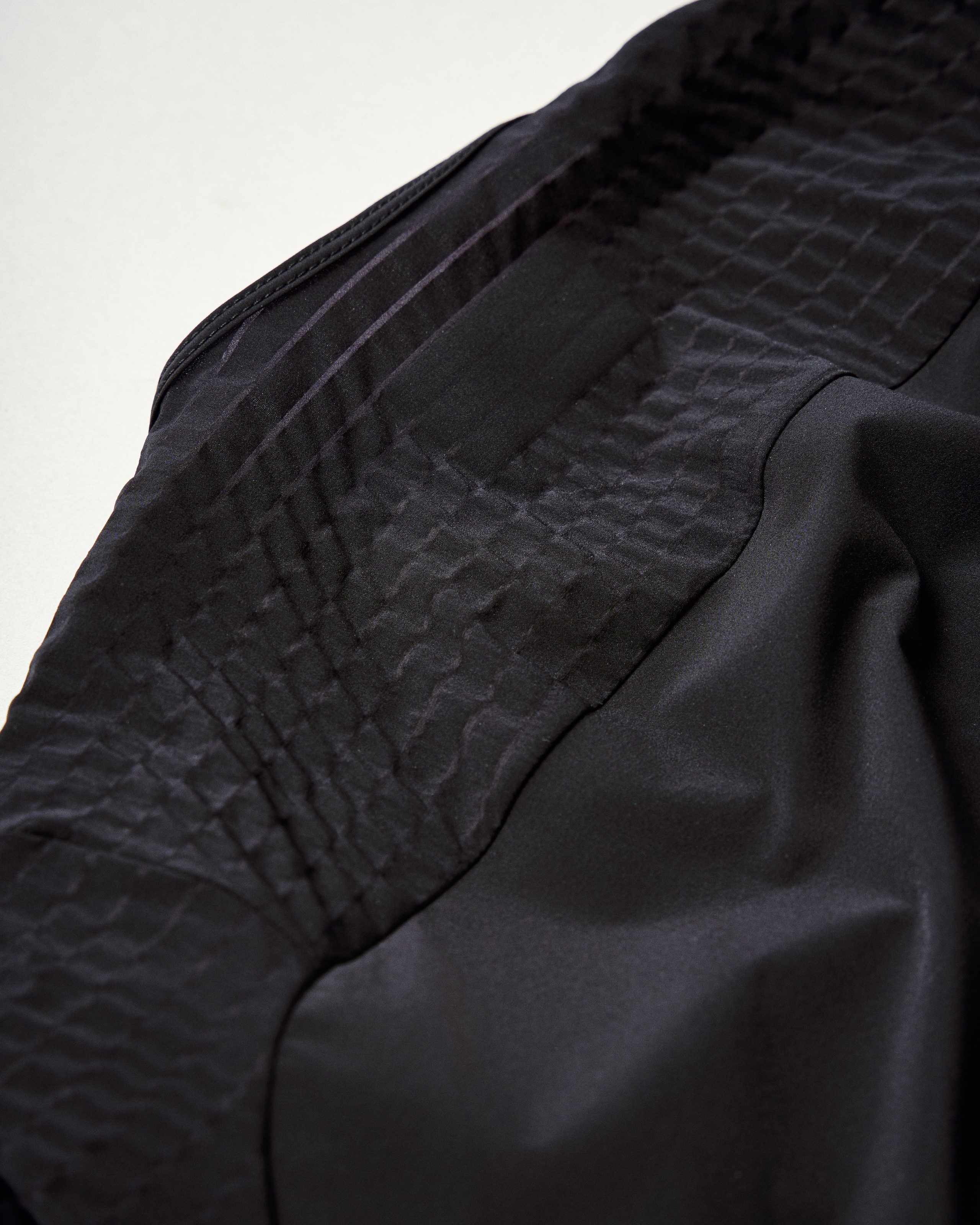 Grey Mechanism Pro cycling jersey, detail view with textured panel construction