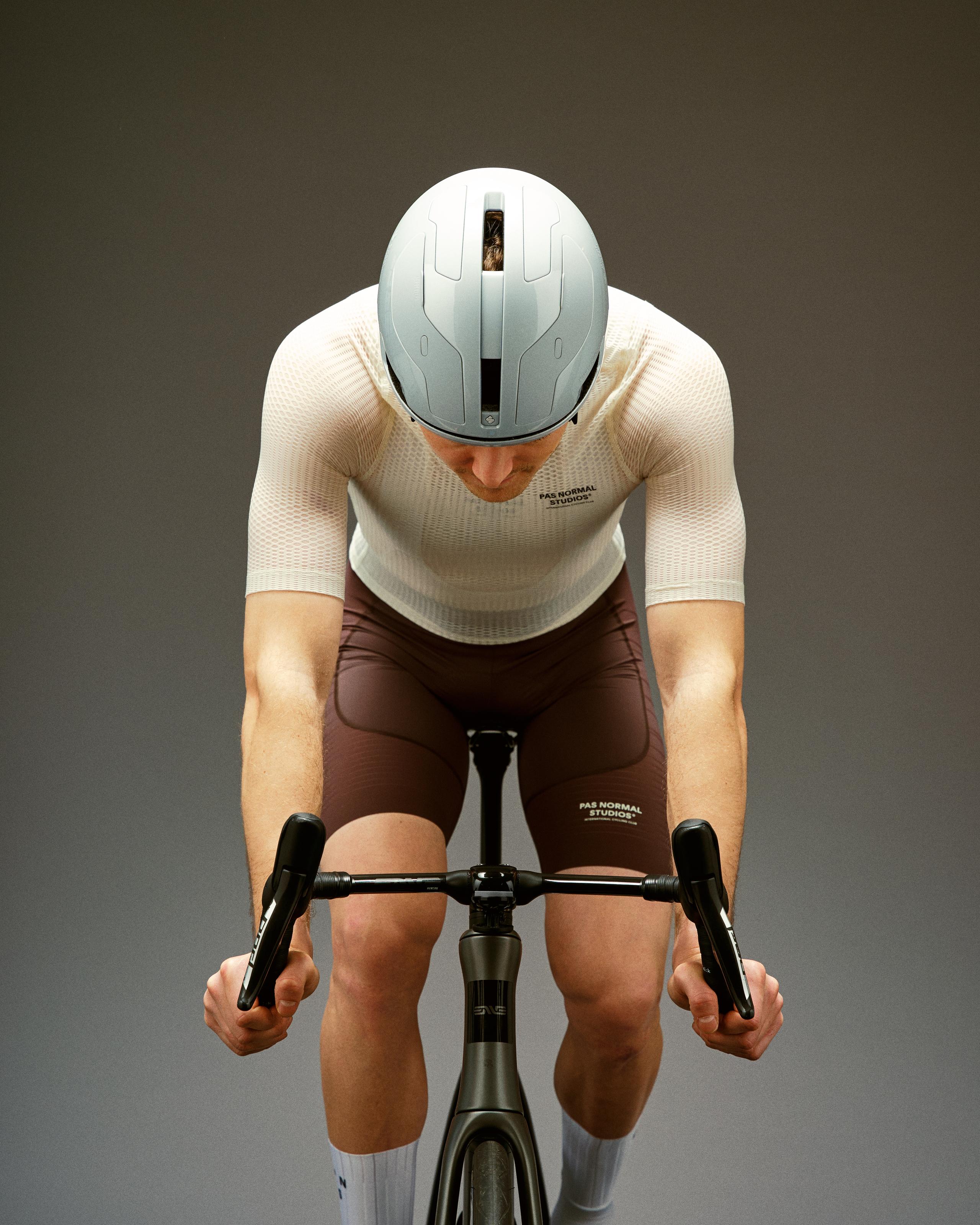 Off White Mechanism Pro Zipless cycling jersey on model in aerodynamic position with textured fabric