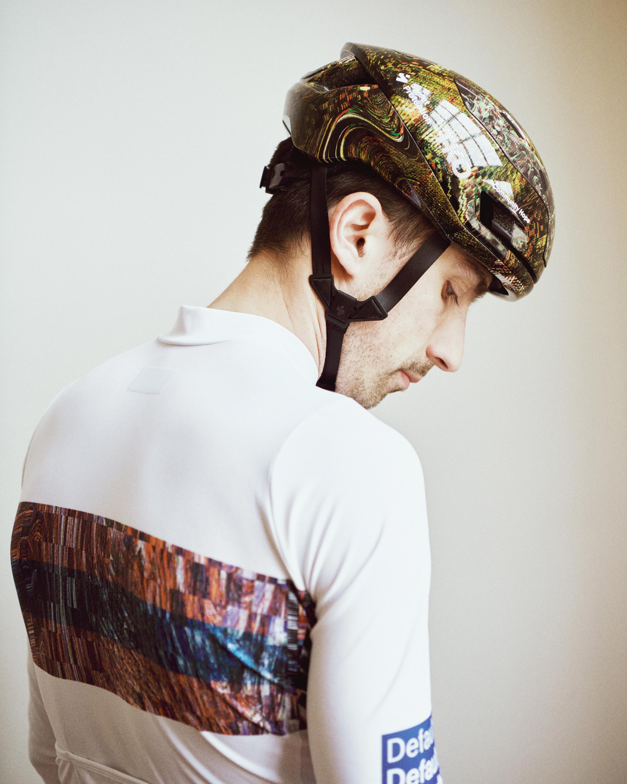 Human Error Green T.K.O. Falconer Aero 2Vi MIPS cycling helmet on model, side view with multicolour graphic shell