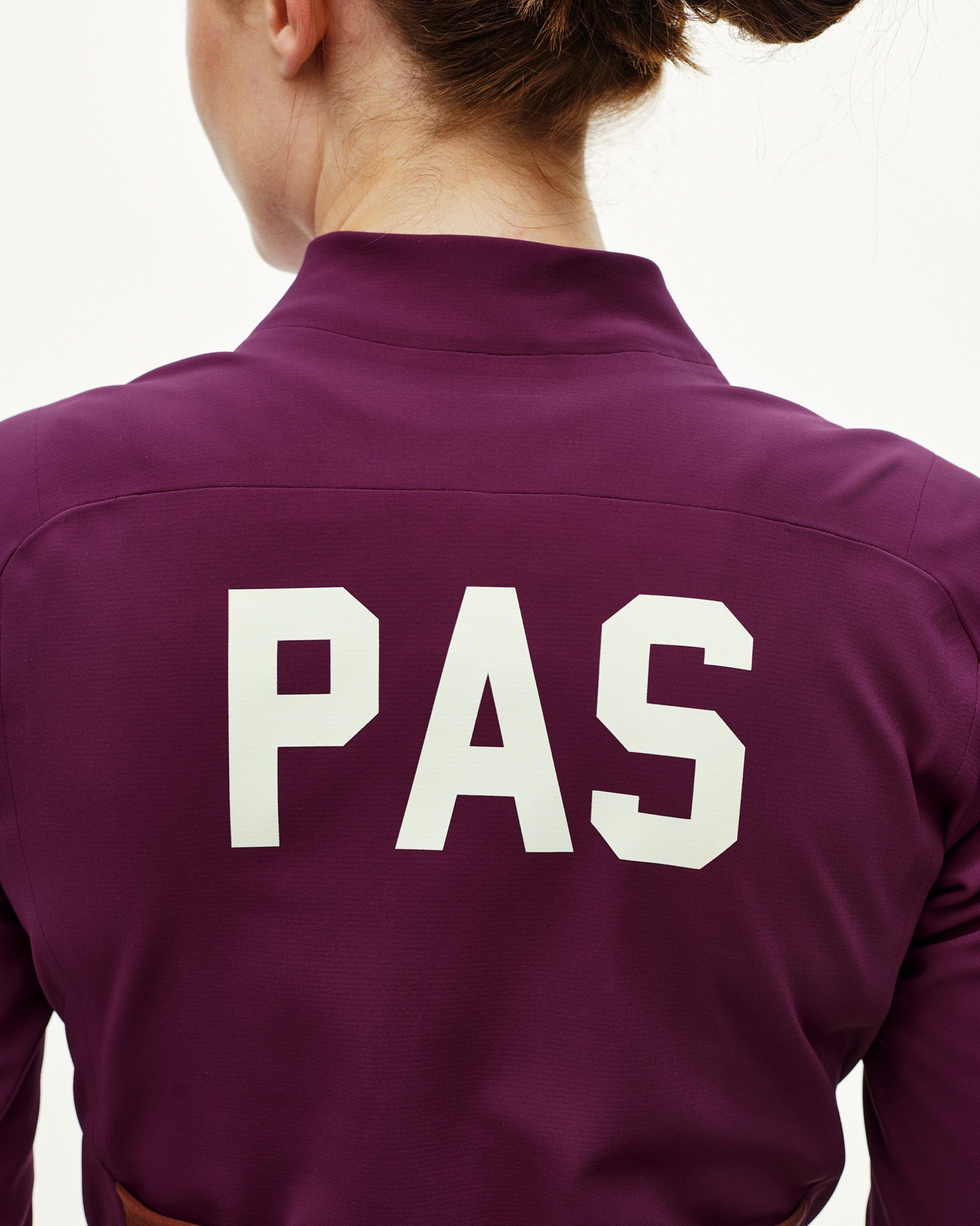 Dark Purple PAS Mechanism Thermal cycling jacket on model, rear view with large white PAS back print