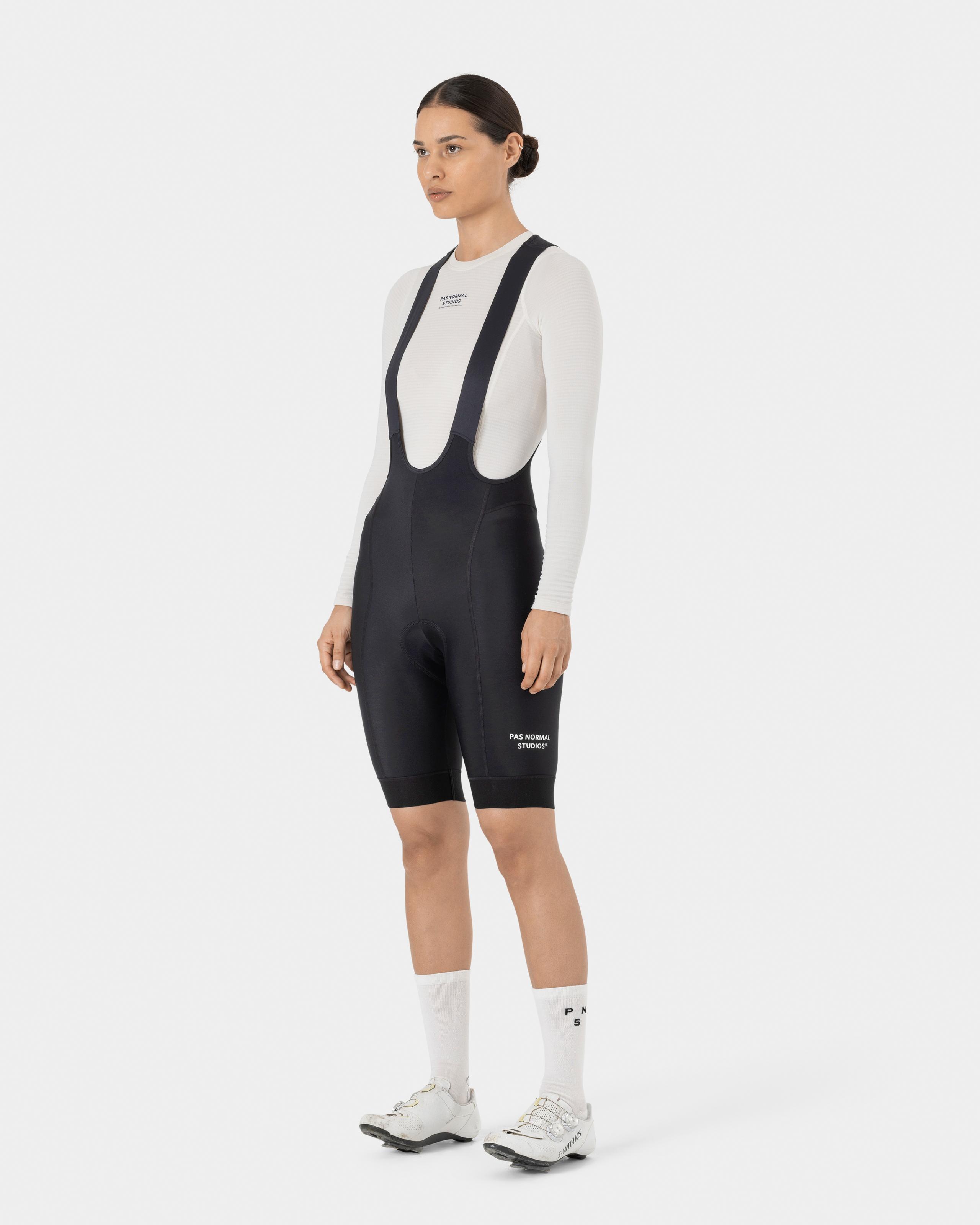 Black Essential Thermal cycling bibs on model with white long sleeve base layer