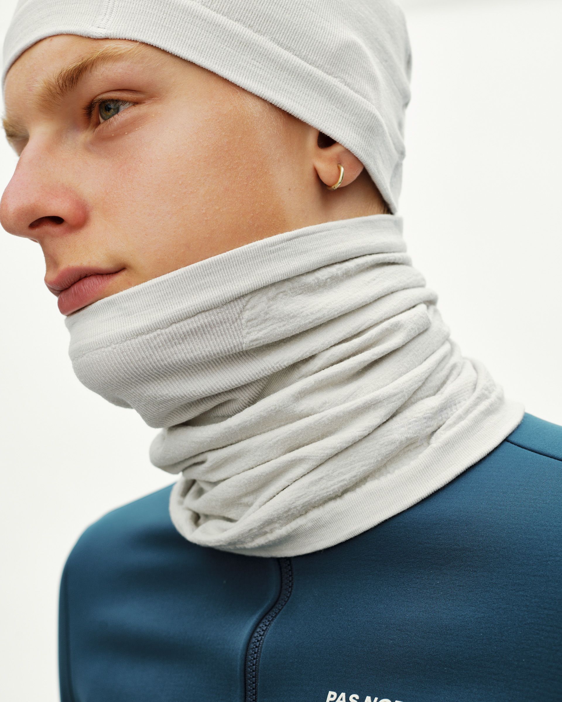 Misty Grey Essential Logo Merino Knit necktube on model, side view with ribbed edge