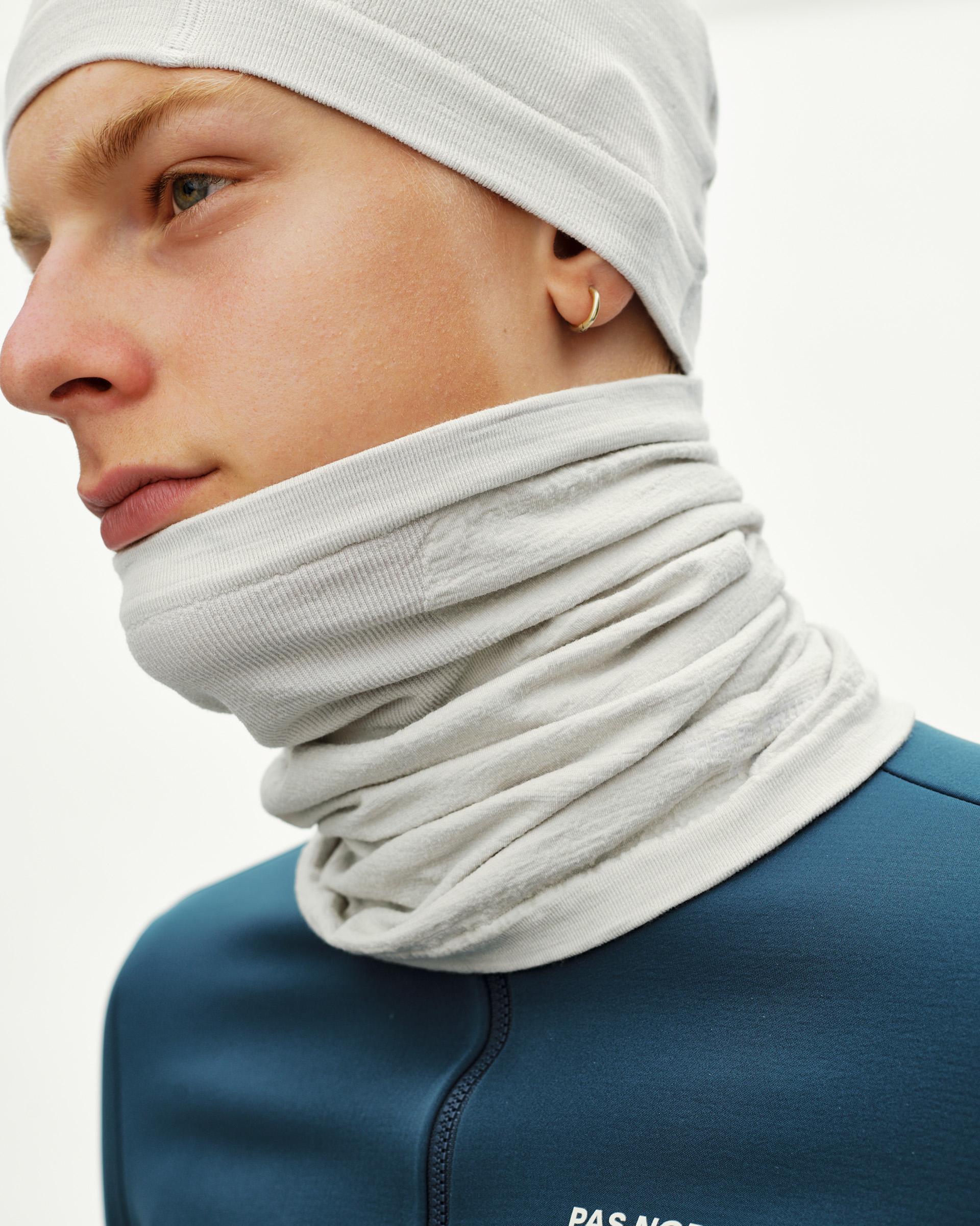 Misty Grey Essential Logo Merino Knit necktube on model, side view with ribbed edge