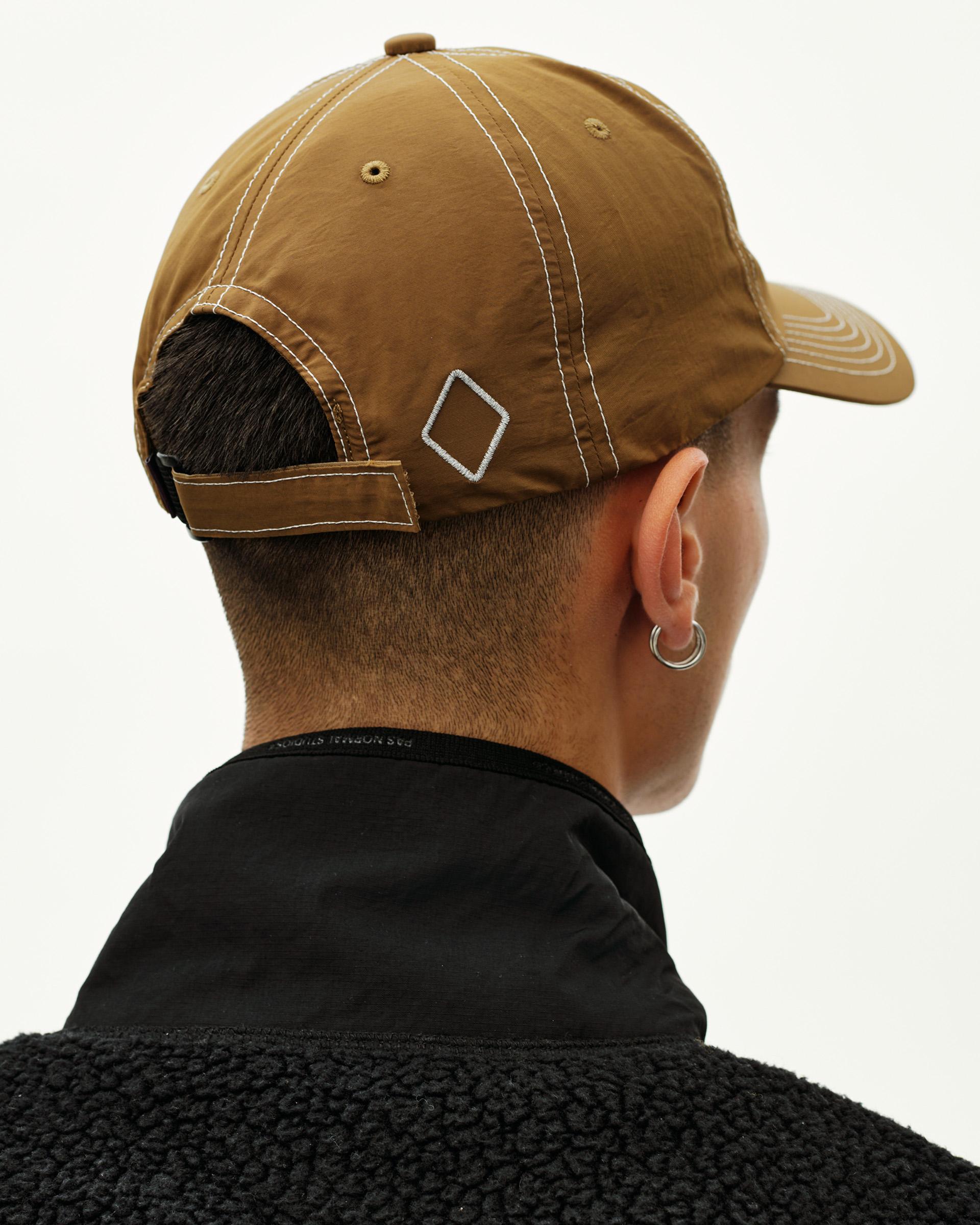 Wood brown Off-Race cap on model, rear view with contrast stitching and diamond logo patch