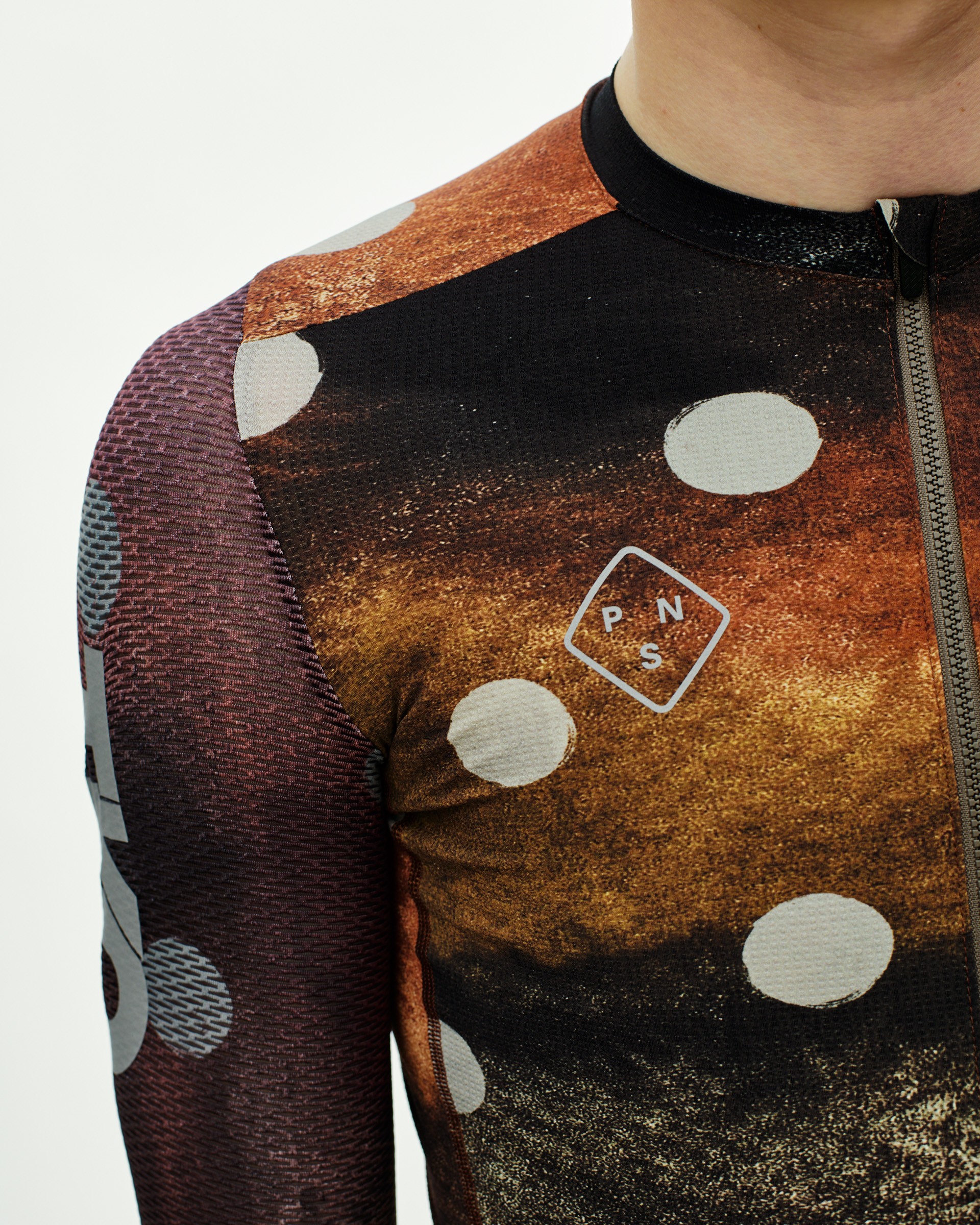 Yellow T.K.O. Essential Light long sleeve cycling jersey on model with white polka dot print