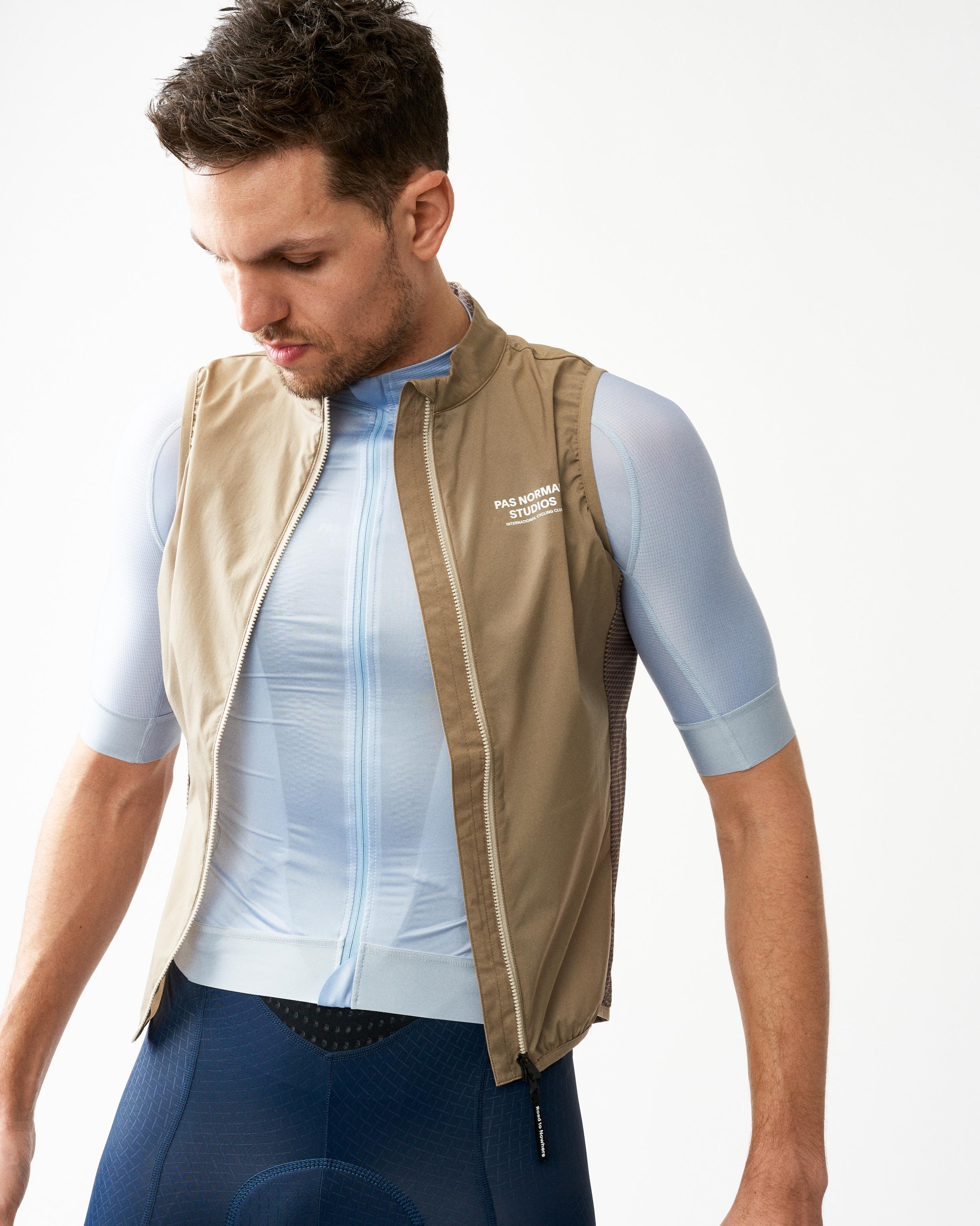 Beige Mechanism Stow Away gilet on model with full zip and mesh back panel