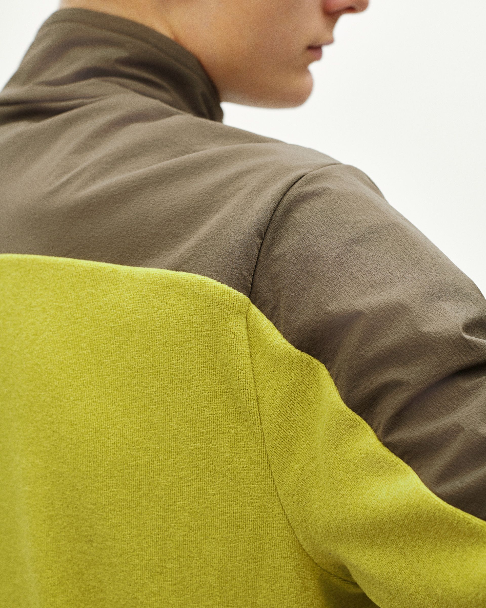 Moss Green Off-Race Light Fleece half-zip, rear view on model with yellow contrast back panel