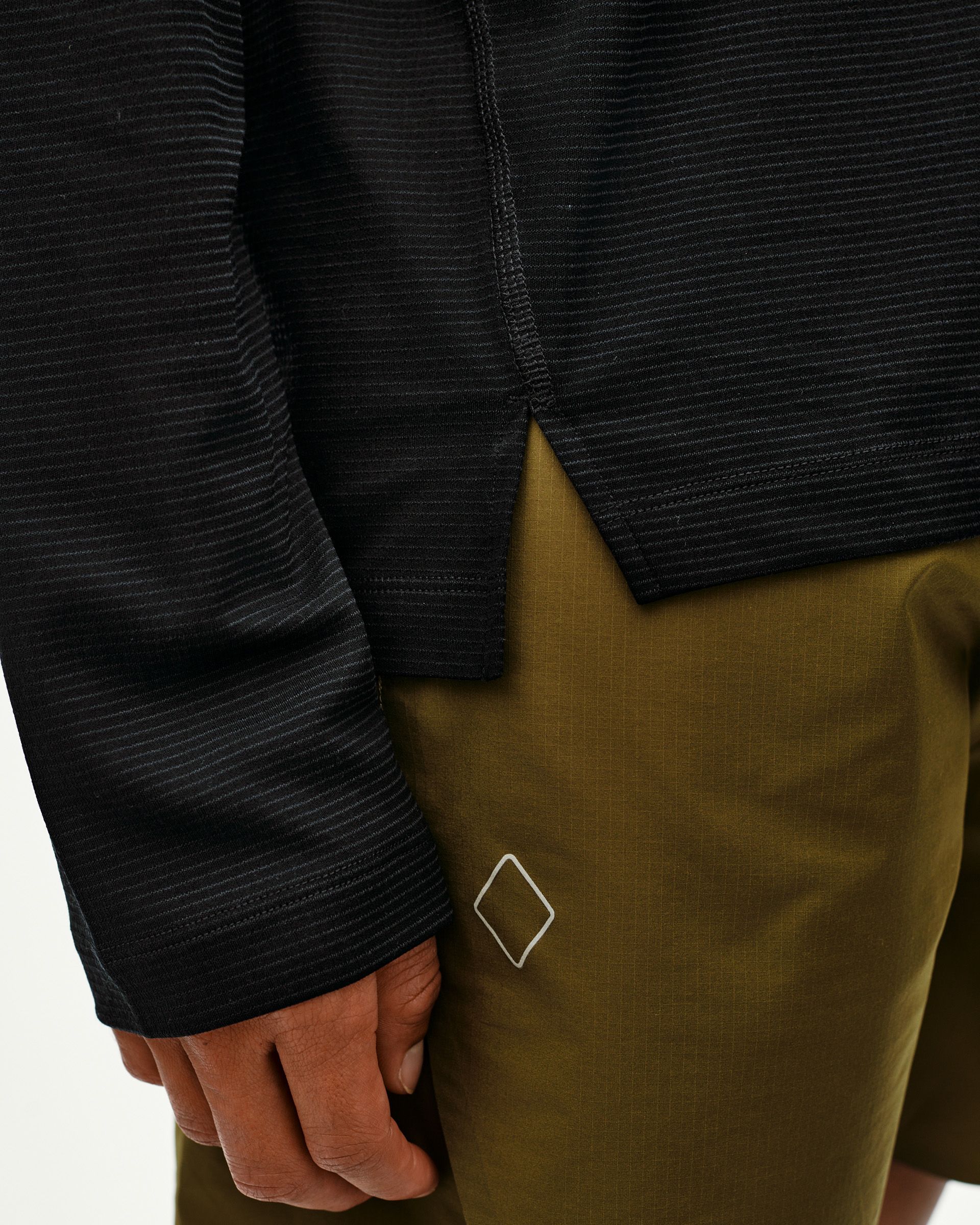 Black Balance long sleeve T-shirt, side detail on model with tonal stripe texture and ribbed cuff
