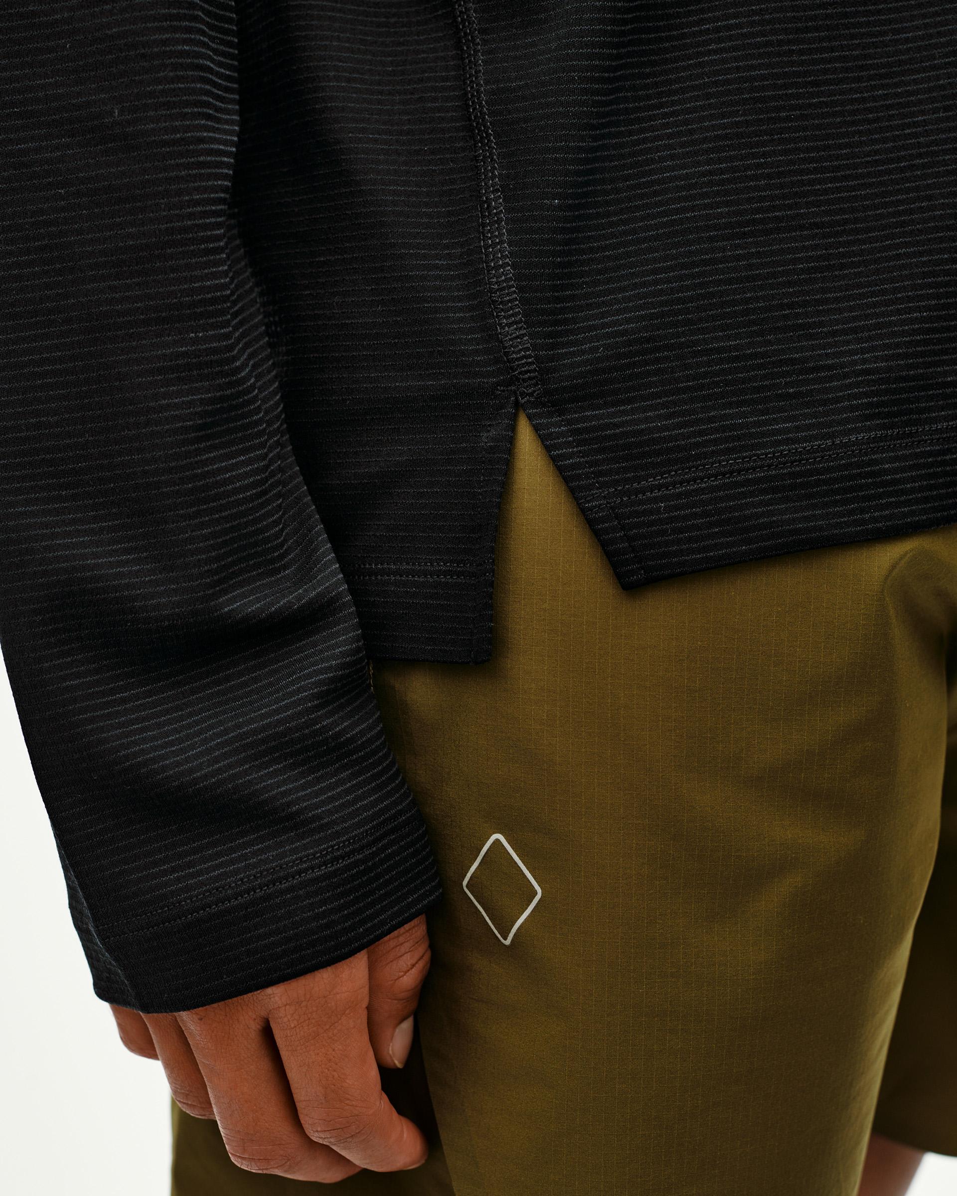 Black Balance long sleeve T-shirt, side detail on model with tonal stripe texture and ribbed cuff