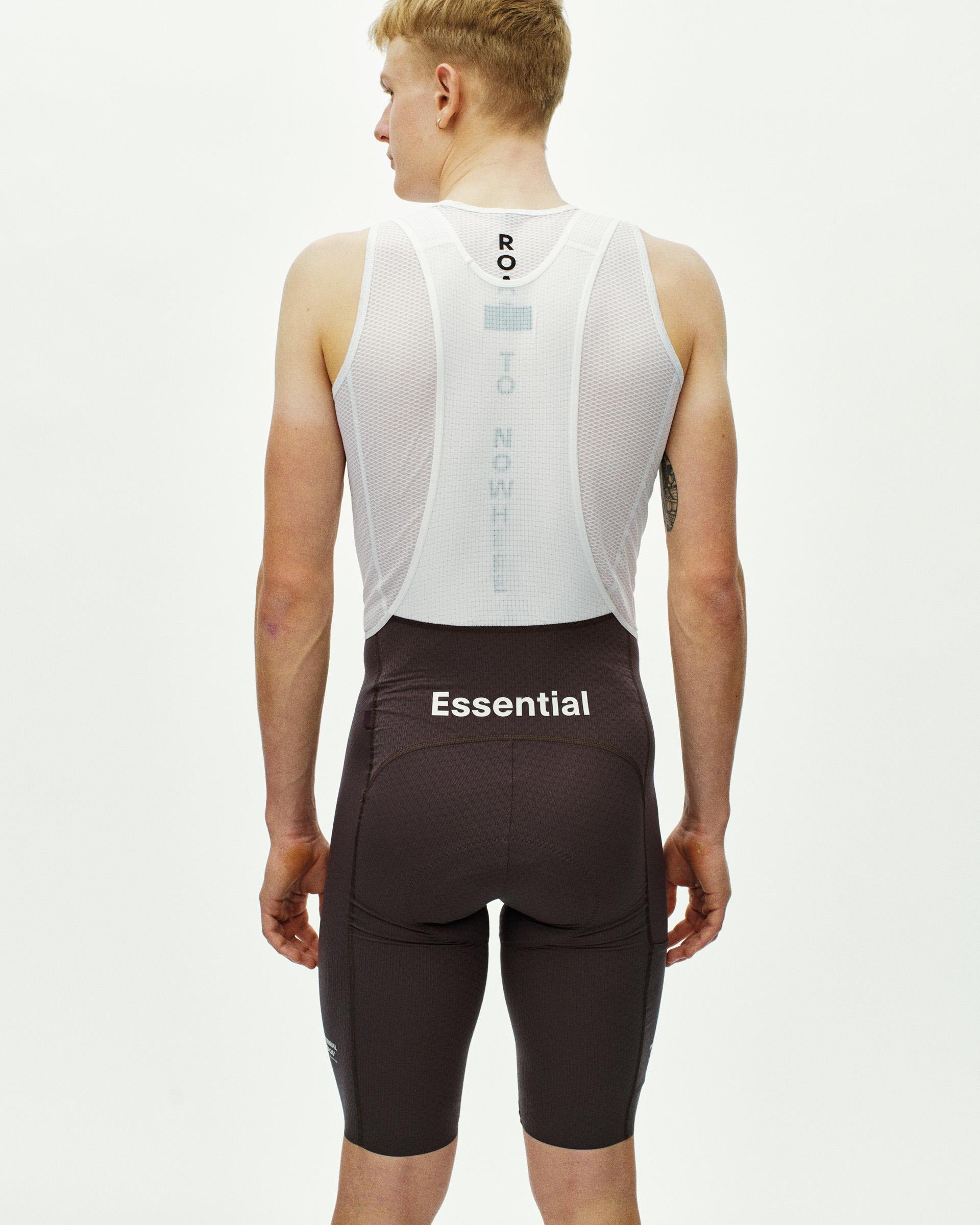 Dark Purple Essential Light Cargo cycling bibs on model, rear view with white mesh base layer