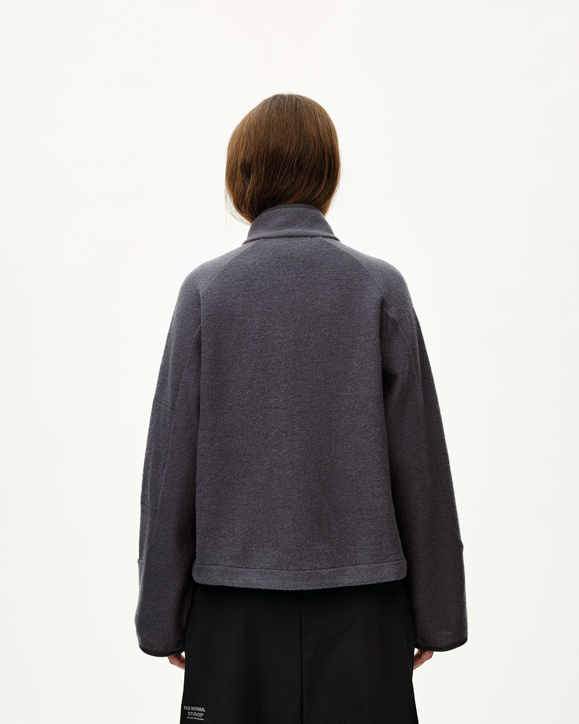 Steel grey Off-Race Boiled Wool jacket on model, rear view with collar and boxy silhouette