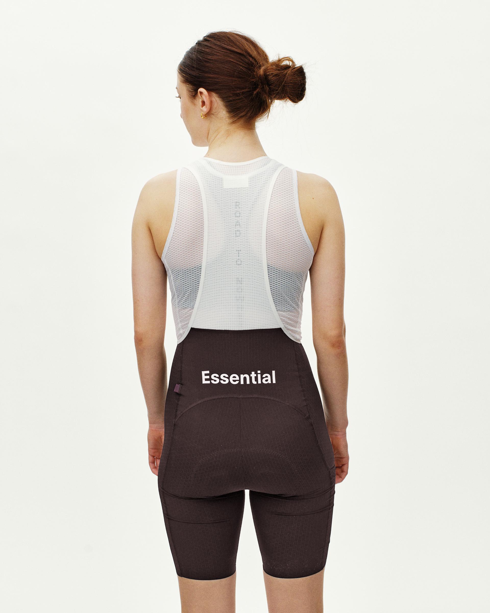 Dark Purple Essential Light Cargo cycling bibs on model, rear view with mesh upper panel and Essential logo