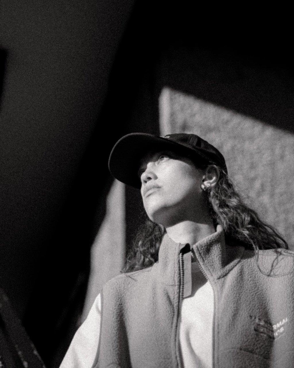 Model wearing Off-Race cap and zip hoodie in black and white portrait shot