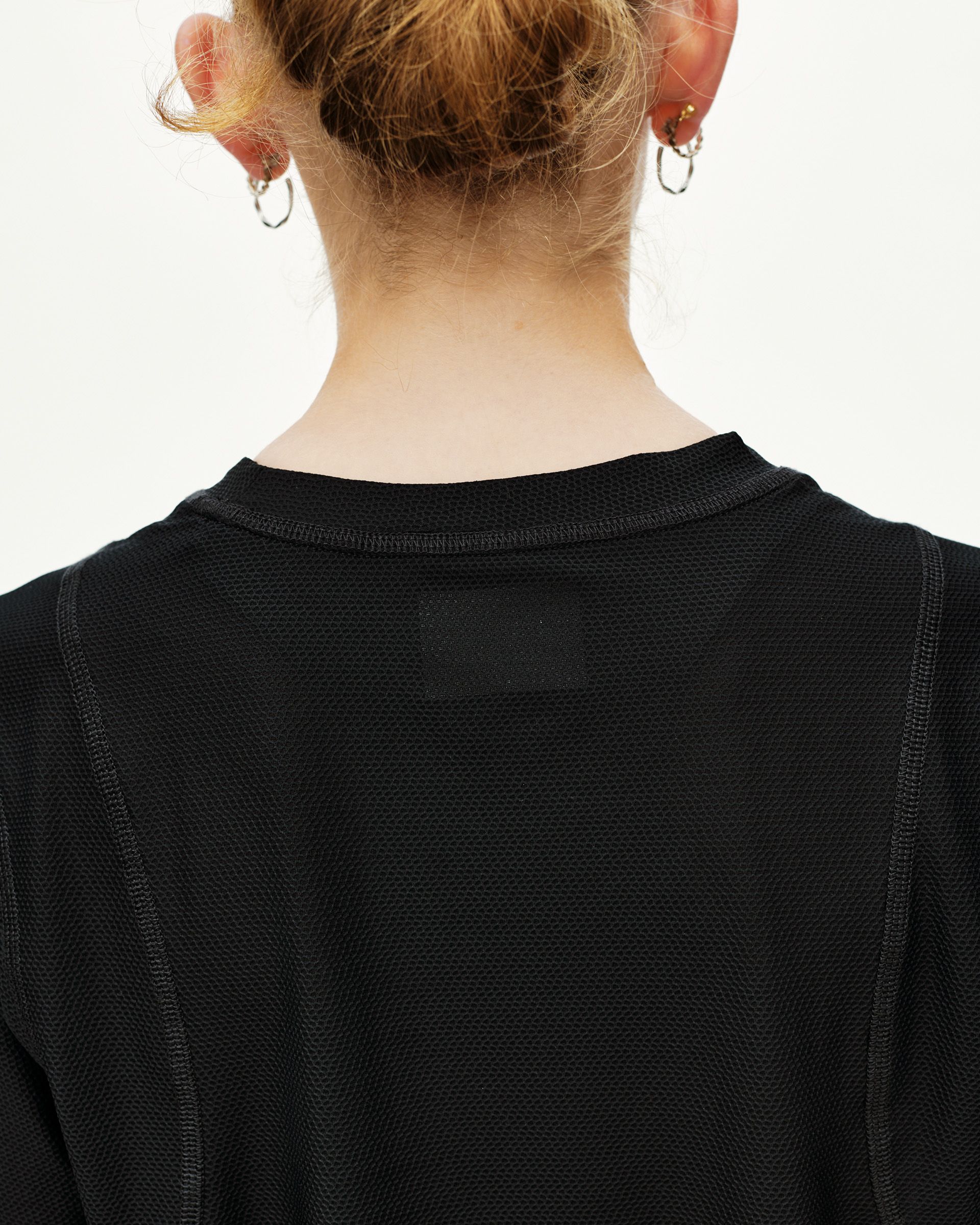 Black Balance T-shirt, rear detail on model showing mesh texture and crew neckline