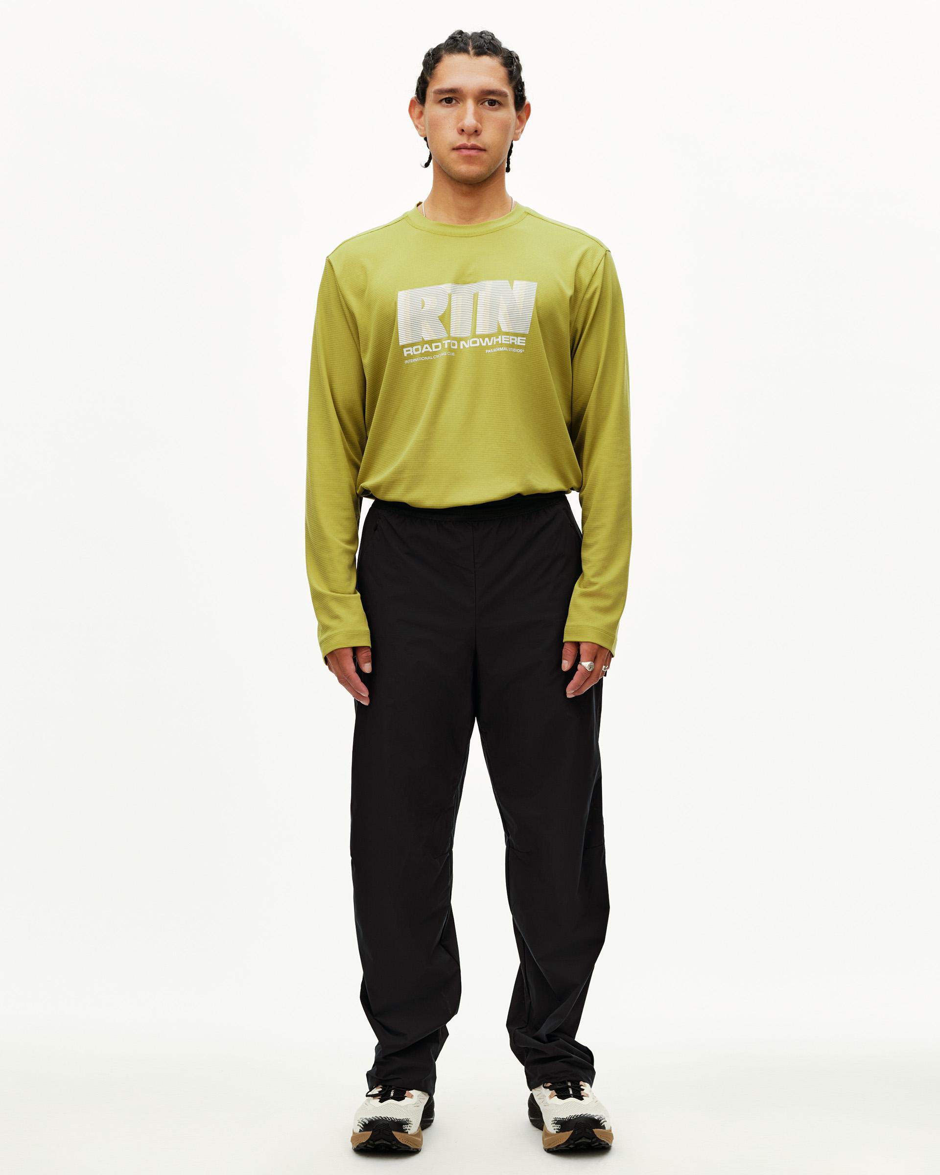Black Balance performance pants on model, front view with elastic waistband and relaxed fit