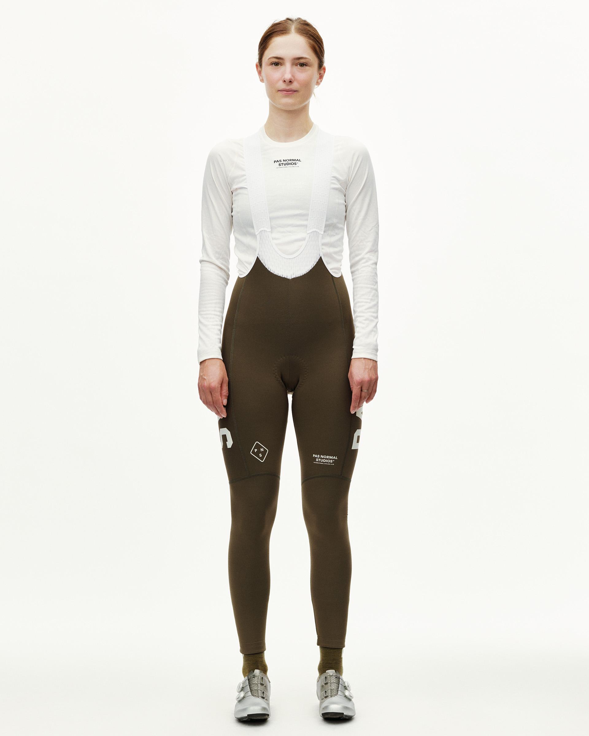 Dark Earth brown PAS Mechanism Thermal women's cycling long bibs on model, front view with white logo print