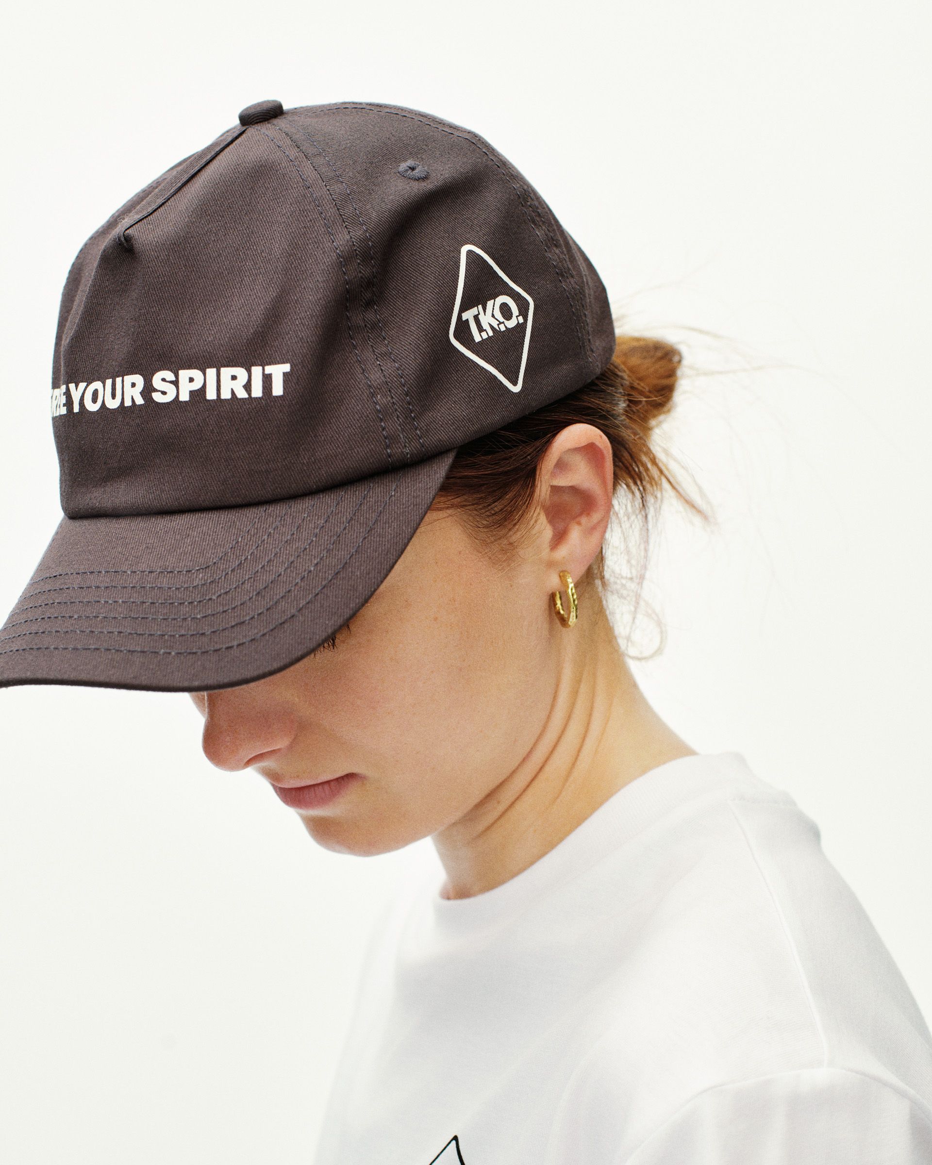 Dark Purple T.K.O. Off-Race cap on model, side view with white text print and diamond logo