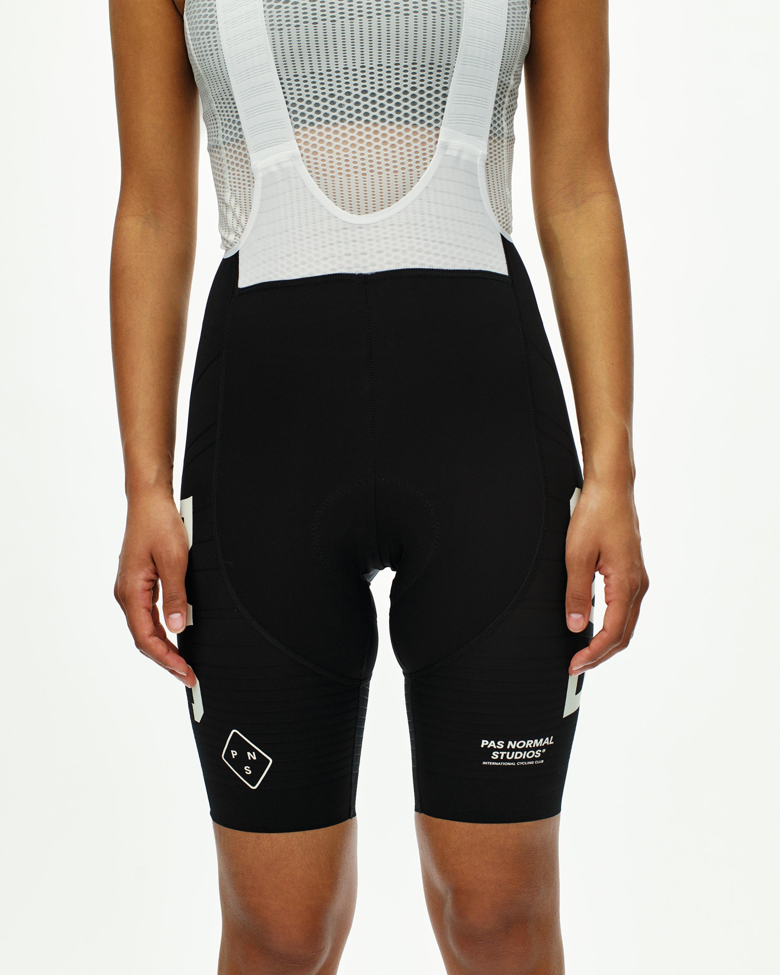 Black PAS Mechanism Pro bibs on model, front view with white mesh base layer and leg branding