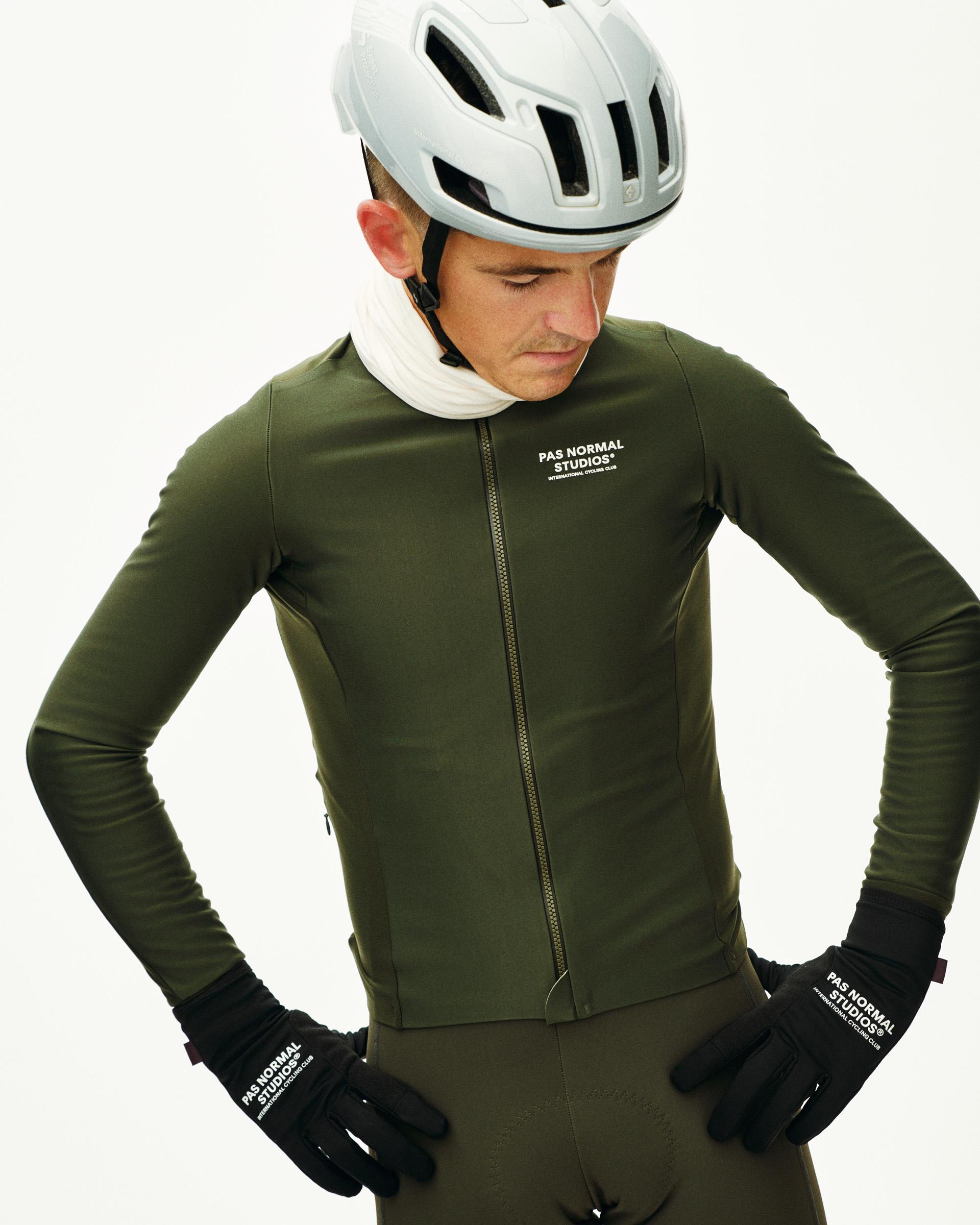 Dark Olive Mechanism Thermal long sleeve cycling jersey on model with full zip and white chest logo