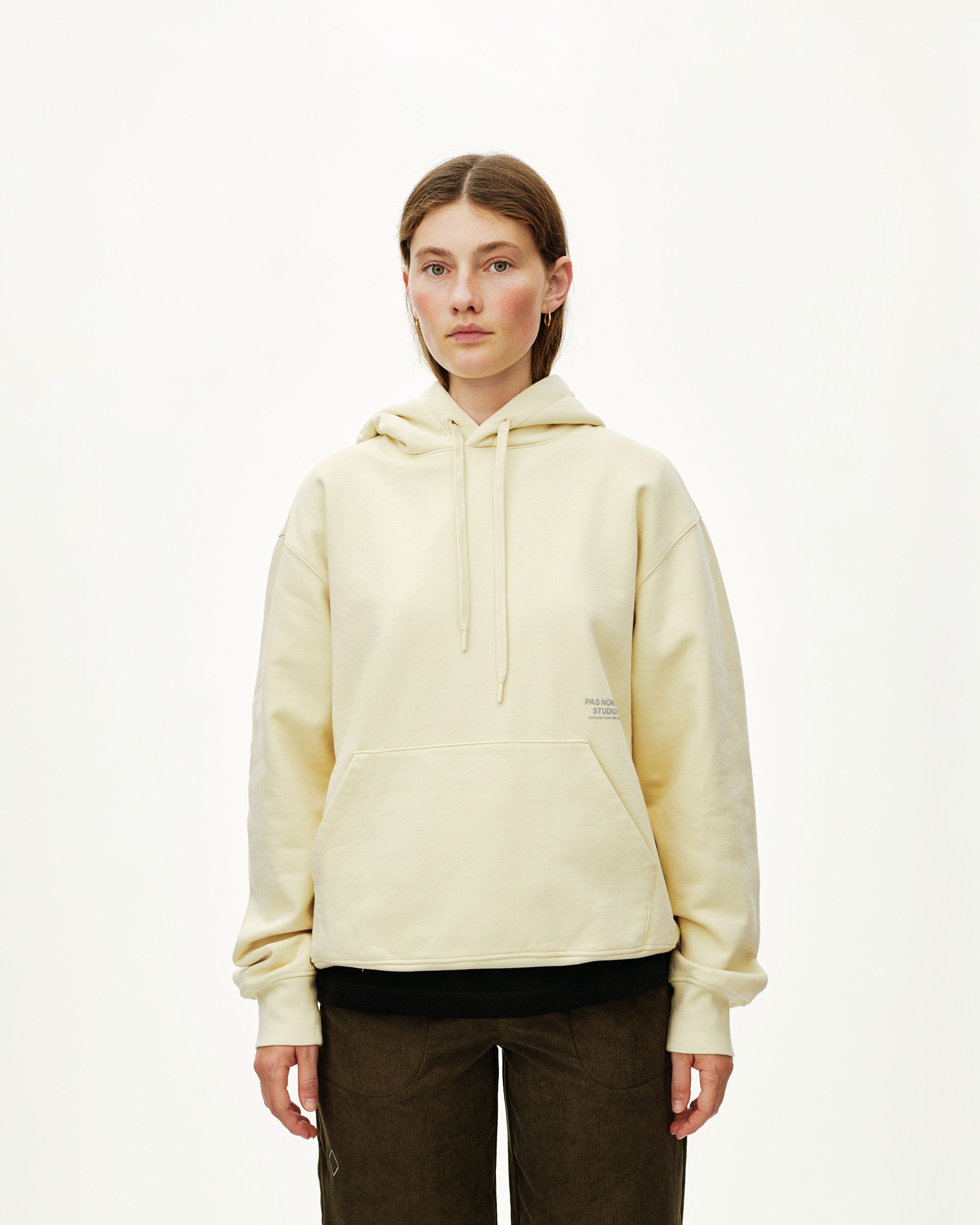 Sand Off-Race hoodie on model, front view with kangaroo pocket and drawstring hood
