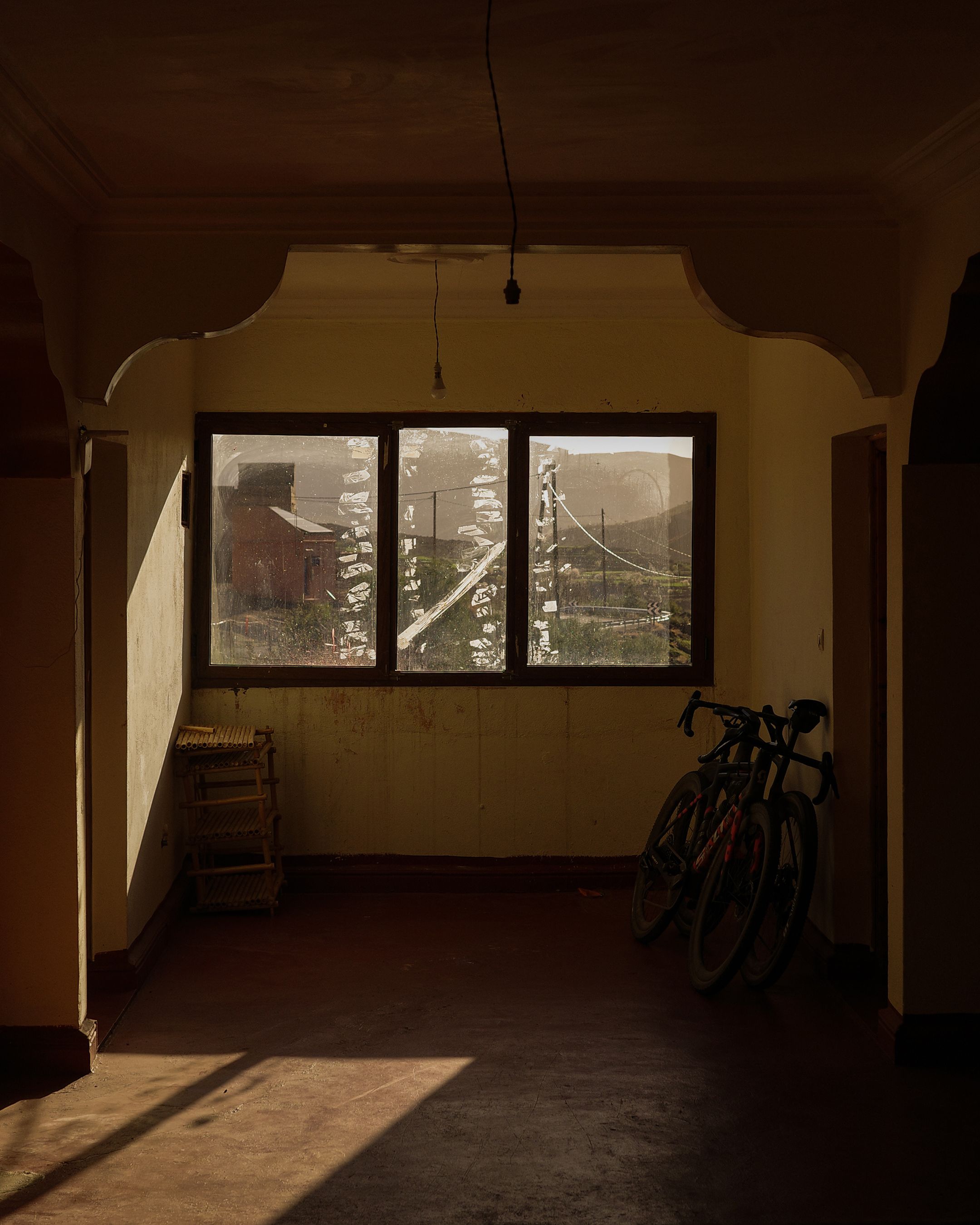 Cyclist's bike in traditional Moroccan interior with mountain view through window