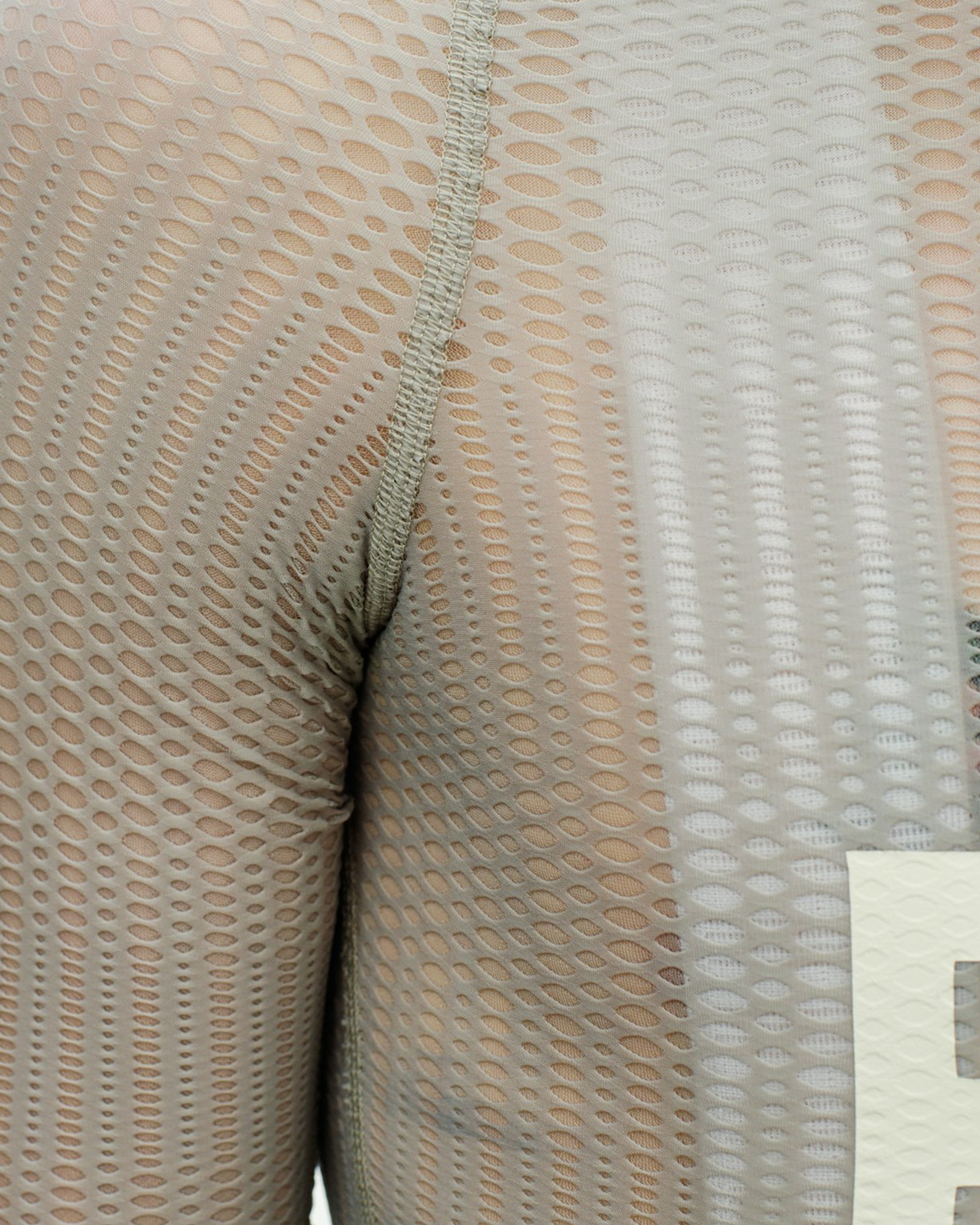 White PAS Mechanism Pro Zipless cycling jersey, detail view showing mesh fabric texture and flatlock seam