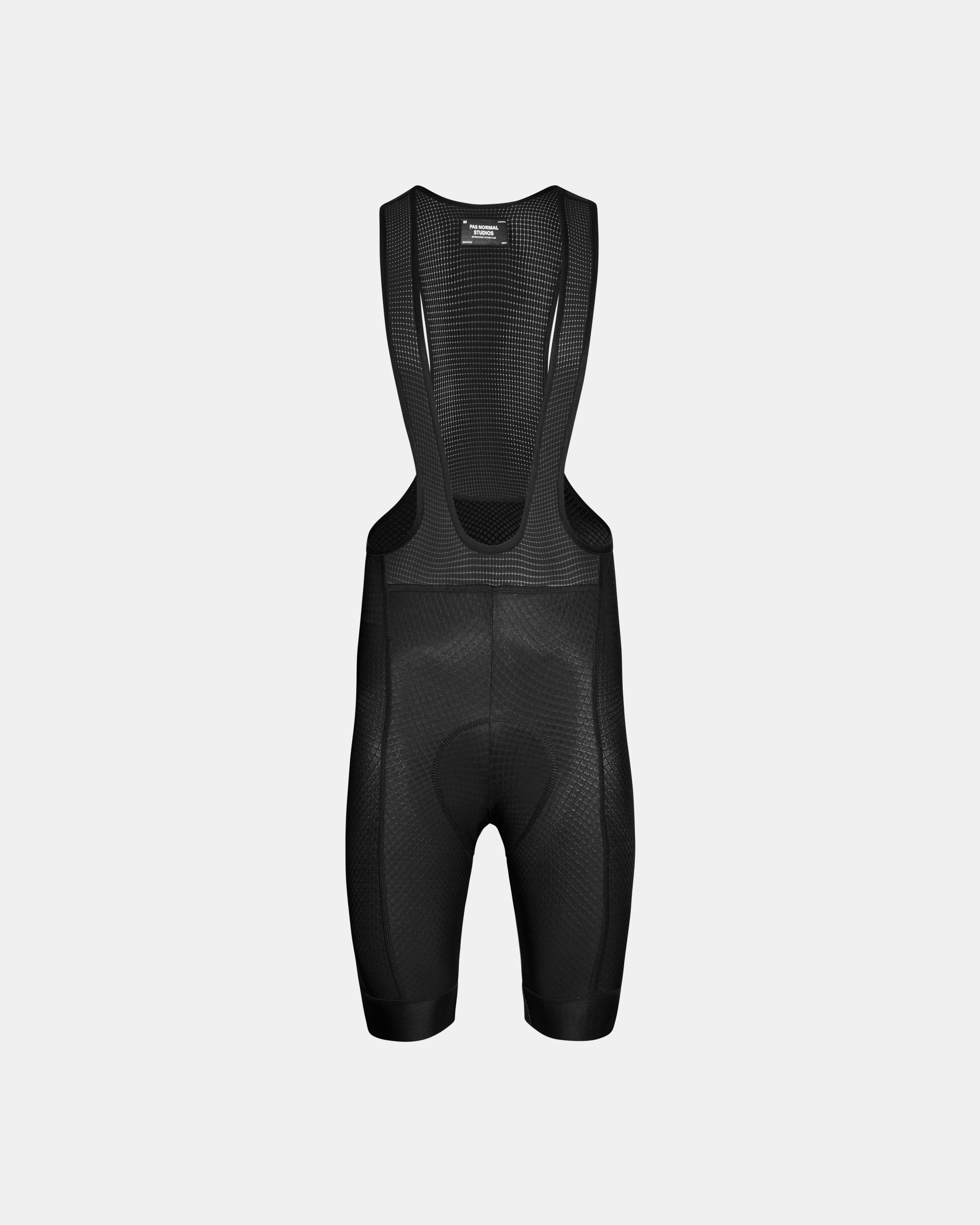 Black Essential cycling bibs, front flat lay with mesh bib panel