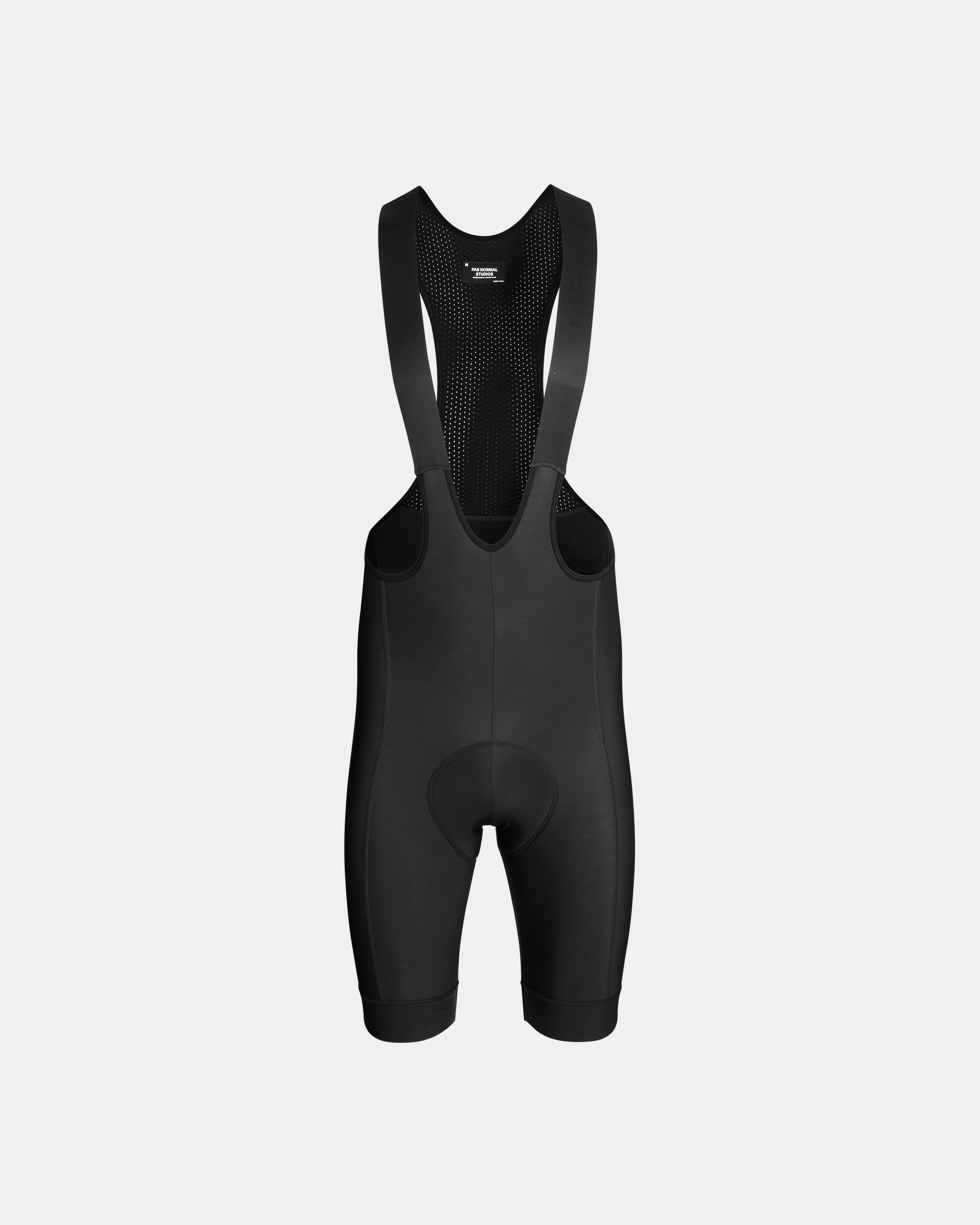 Black Essential cycling bibs, front flat lay with mesh back panel