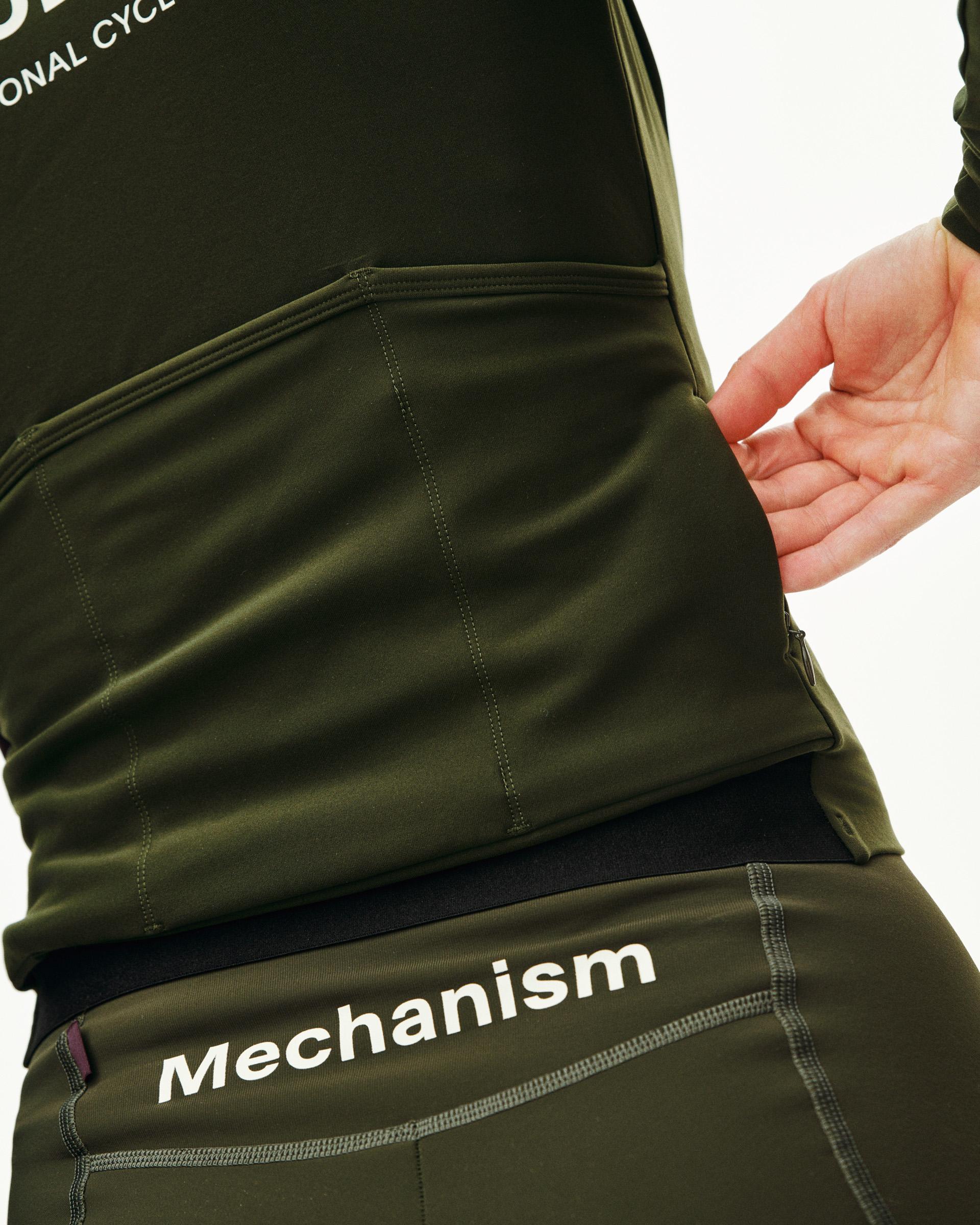 Dark Olive Mechanism Thermal long sleeve cycling jersey on model, side view with white logo print