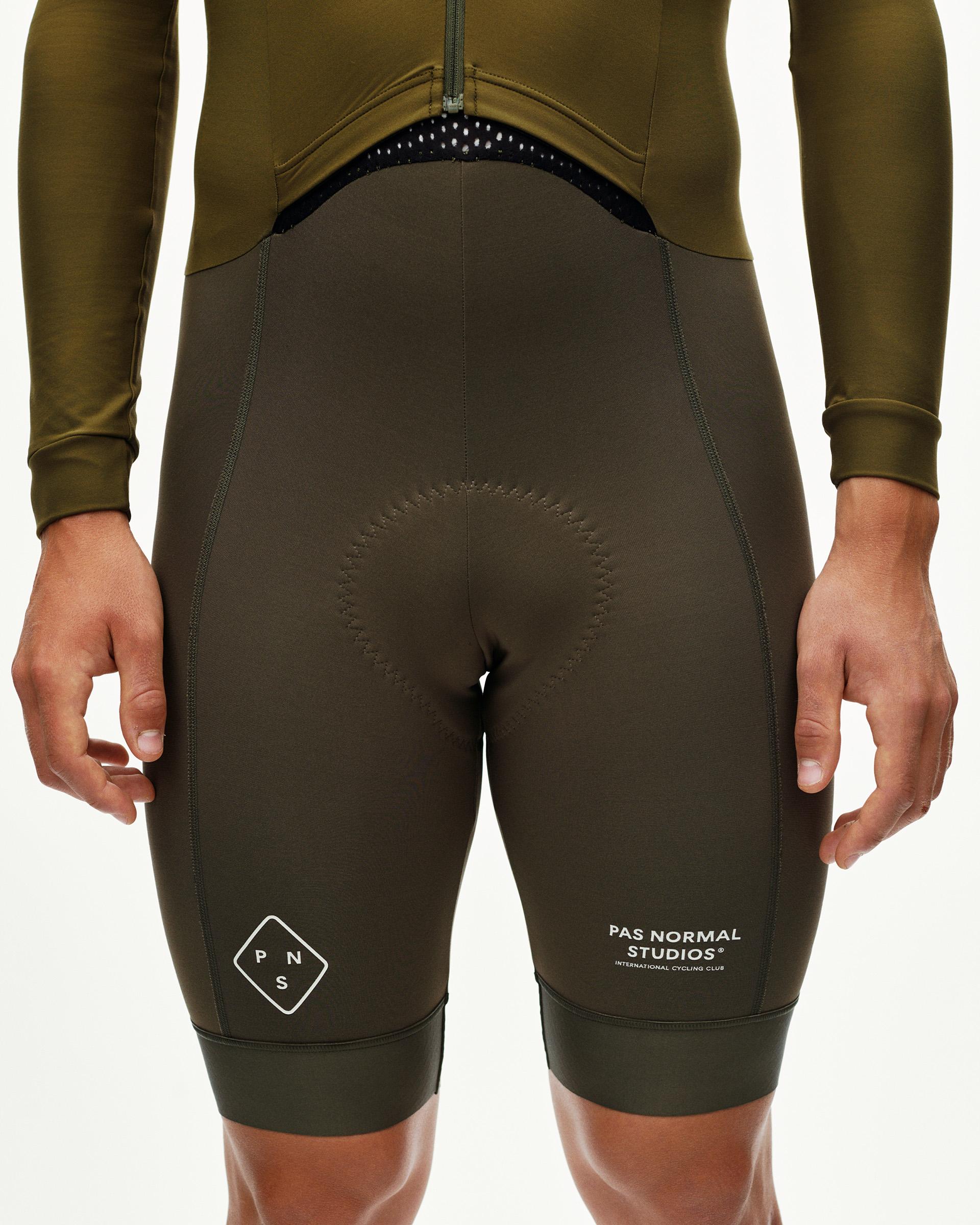 Moss Brown PAS Thermal Speedsuit, front detail on model with circular tonal stitching at seat
