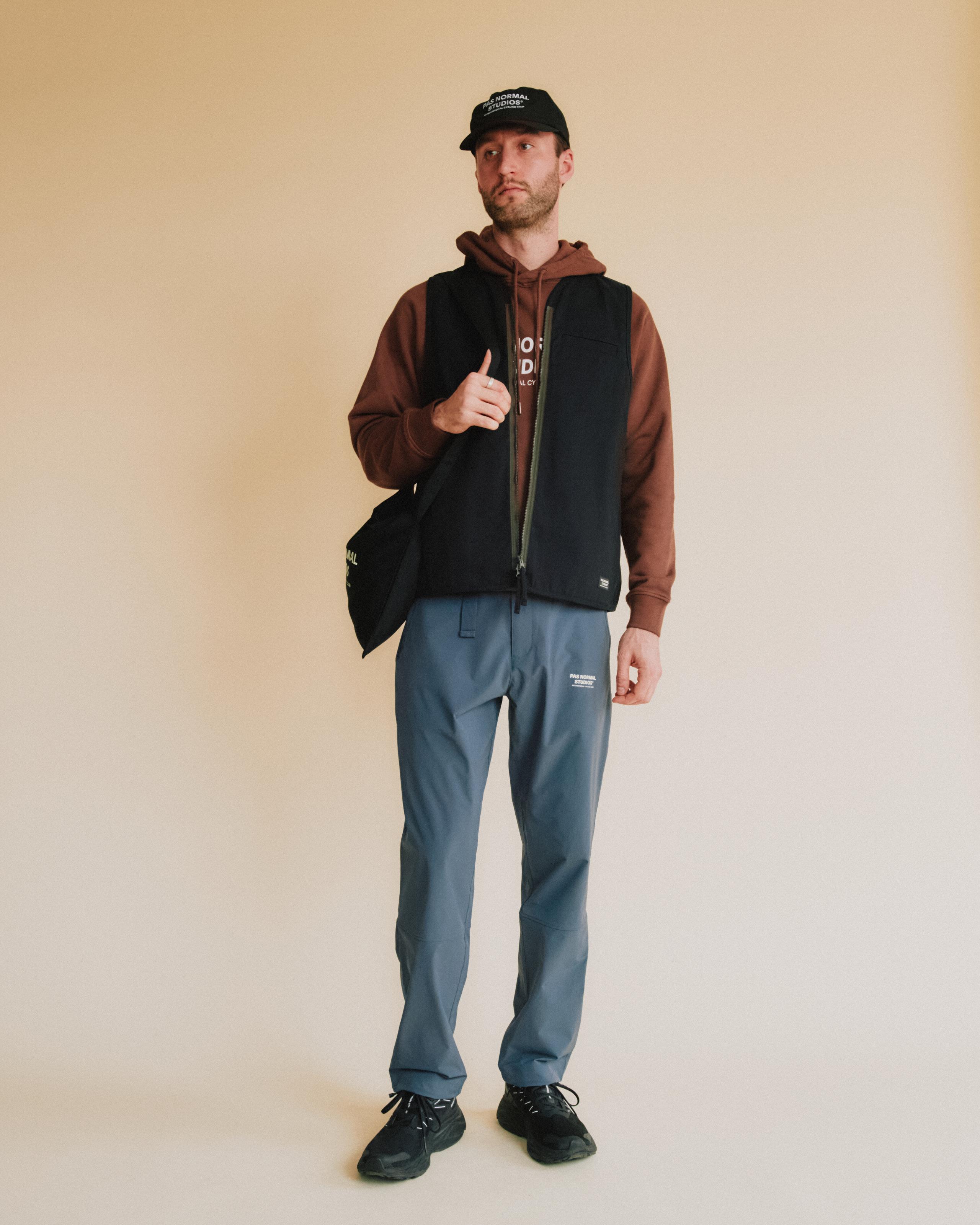 Blue Off-Race pants on model with relaxed fit and front zip pocket