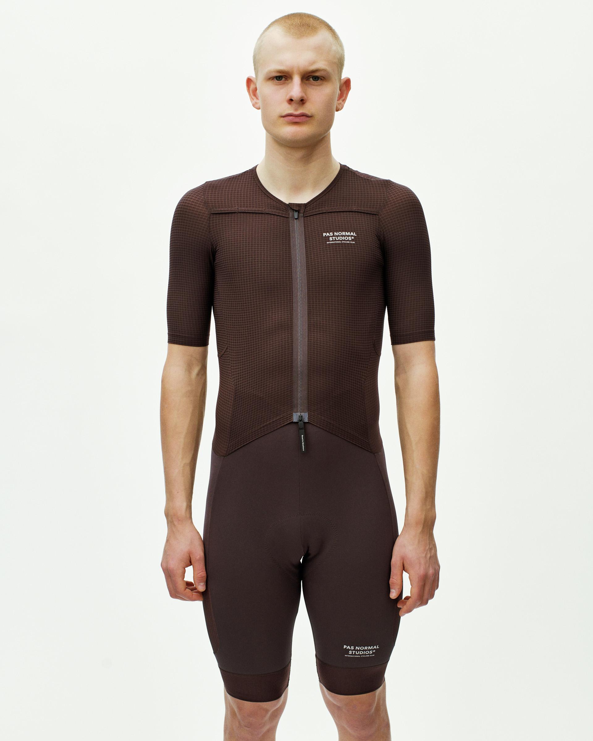 Dark Red Escapism speedsuit on model, front view with textured fabric and full zip