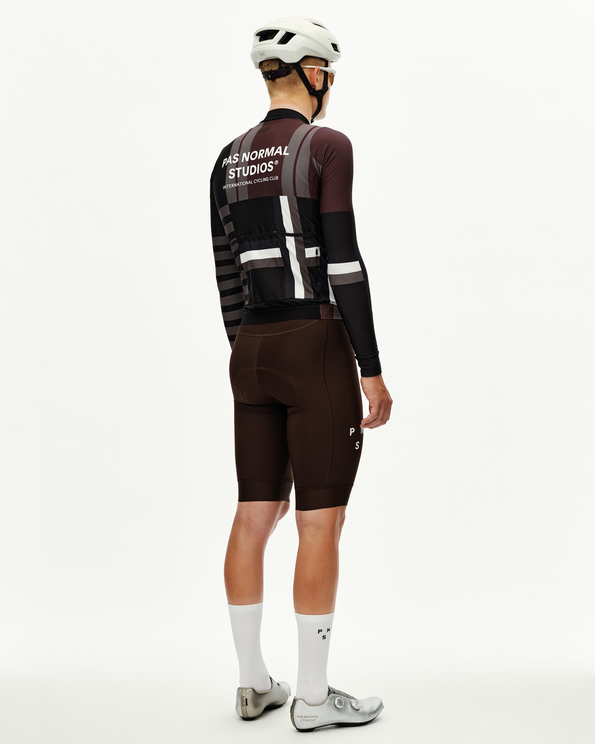 International Dark Olive Mechanism long sleeve cycling jersey on model, rear view with graphic stripe print and back pocket