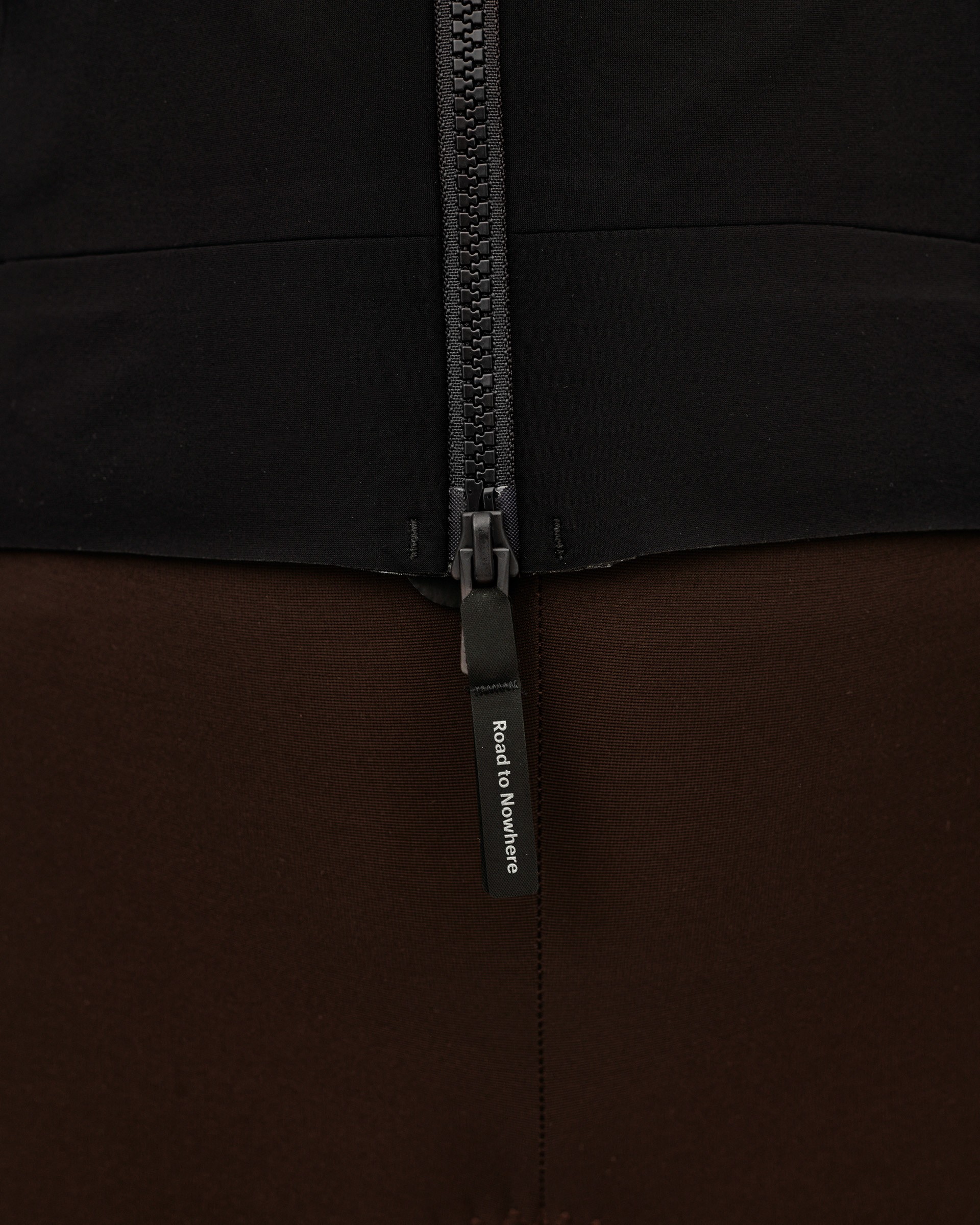 Dark Purple PAS Mechanism Women's thermal cycling jacket, detail view of front zip with branded zipper pull