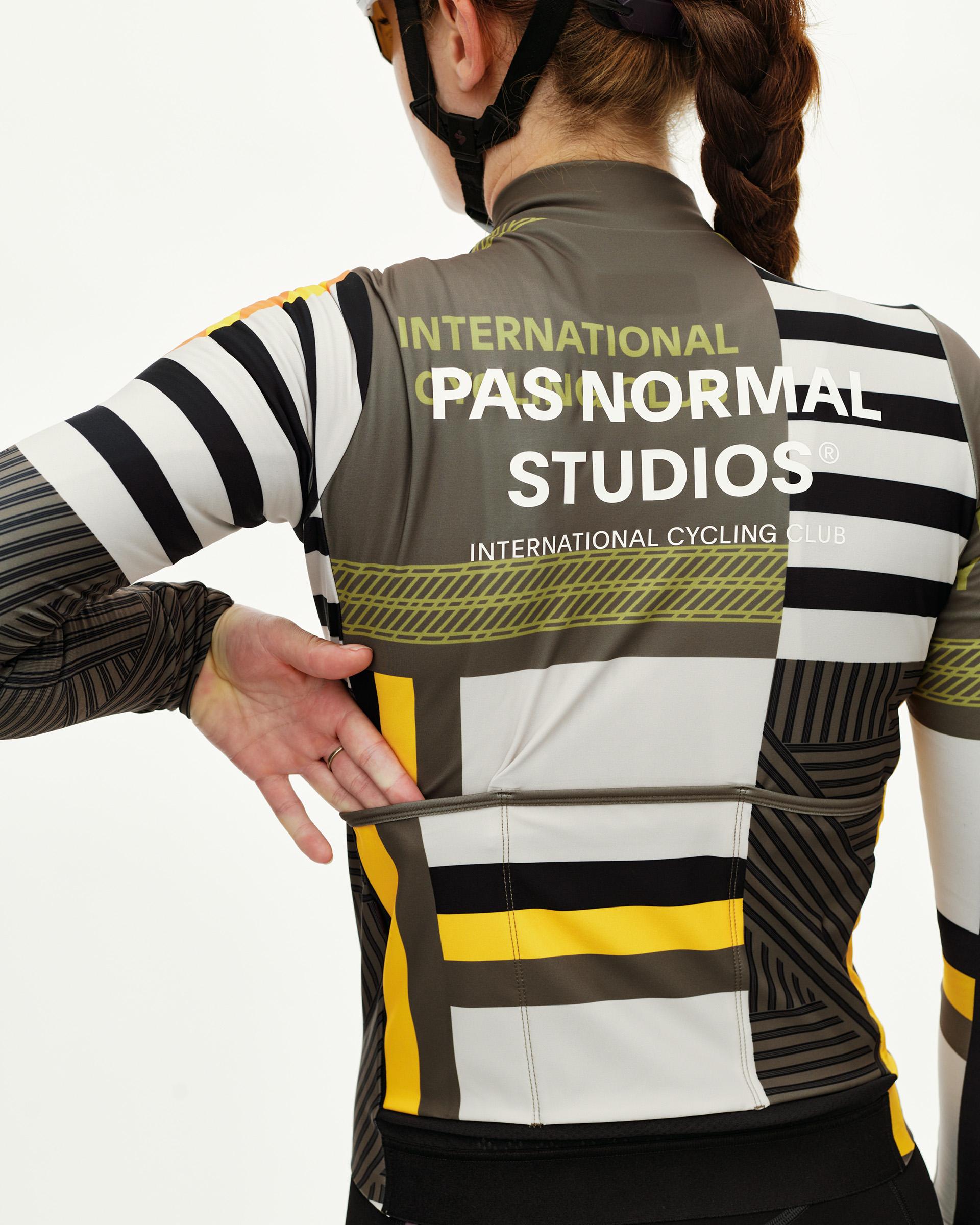 International Sand Mechanism women's long sleeve cycling jersey on model, rear view with graphic block print