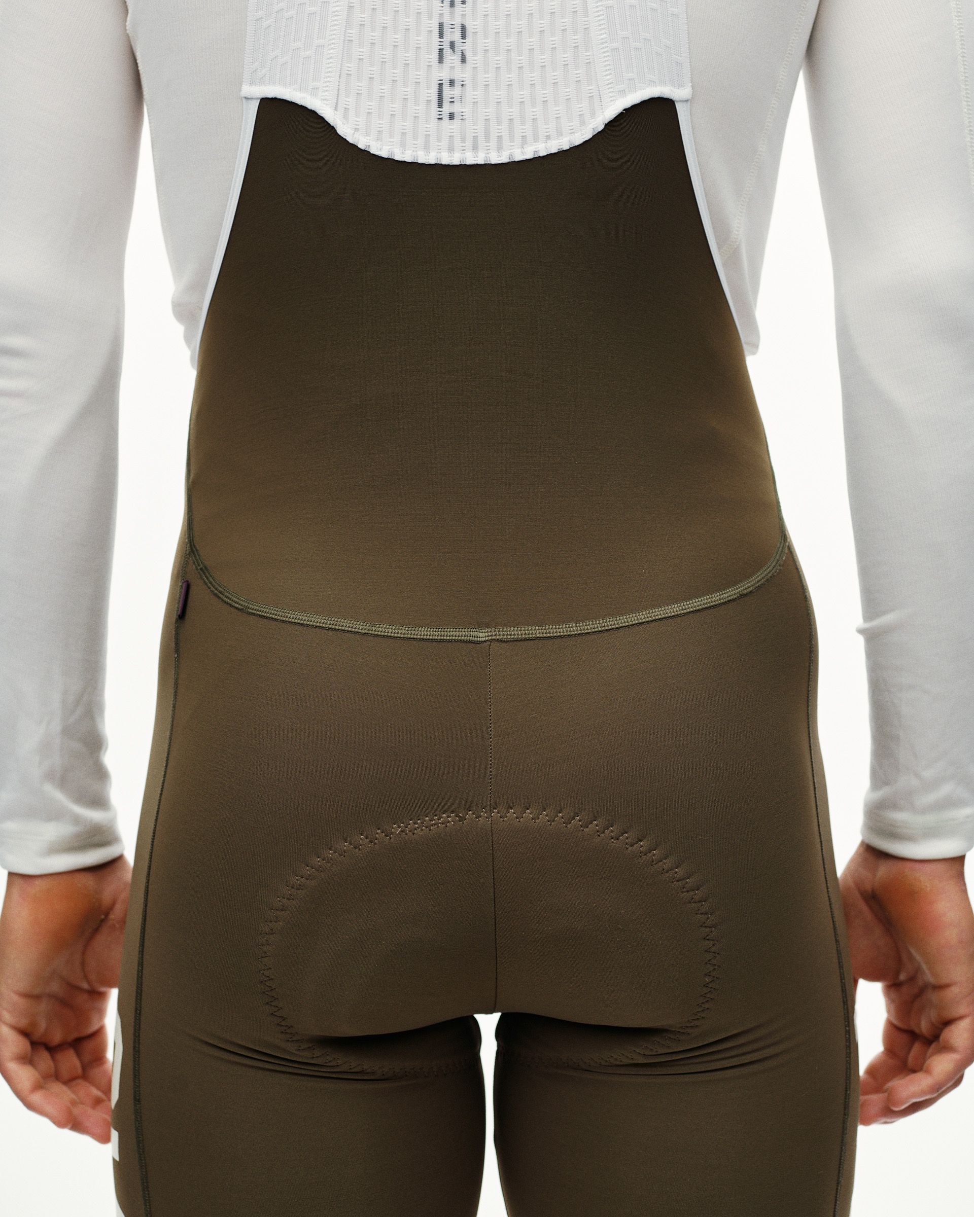 Dark Earth PAS Mechanism thermal cycling long bibs on model, rear detail view with tonal seam stitching
