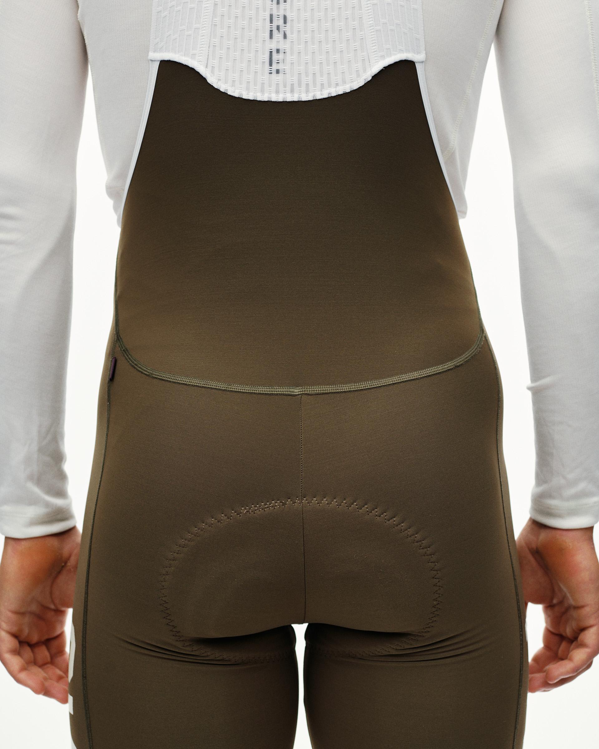 Dark Earth PAS Mechanism thermal cycling long bibs on model, rear detail view with tonal seam stitching