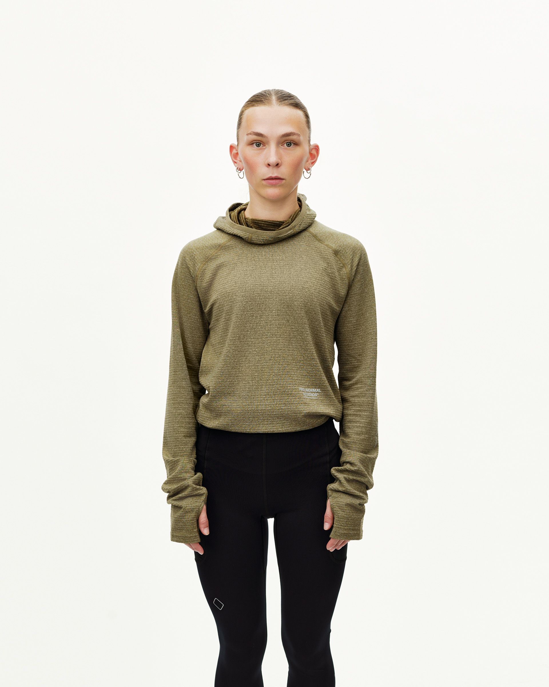 Black Balance long tights on model, front view with small logo patch at knee