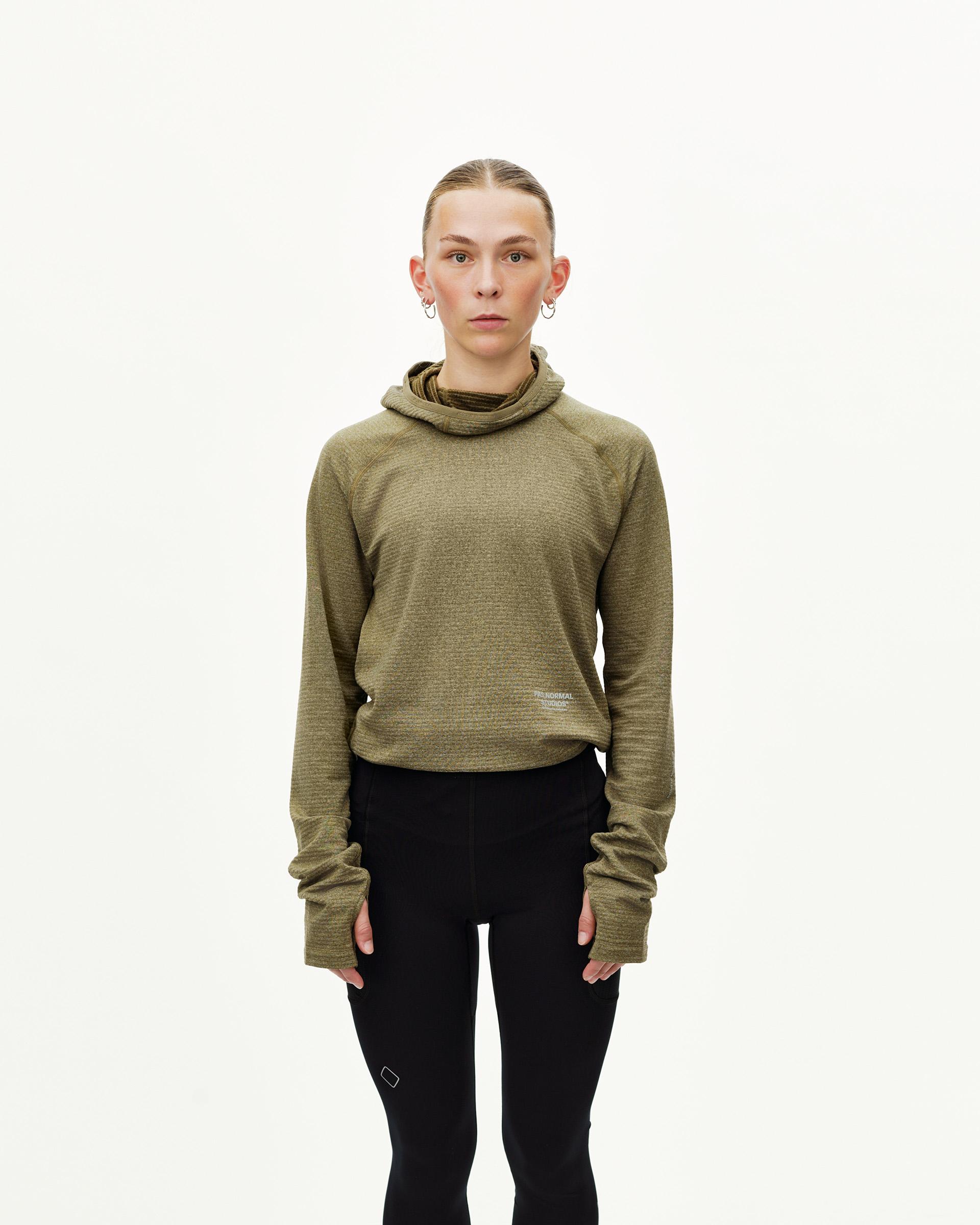 Black Balance long tights on model, front view with small logo patch at knee