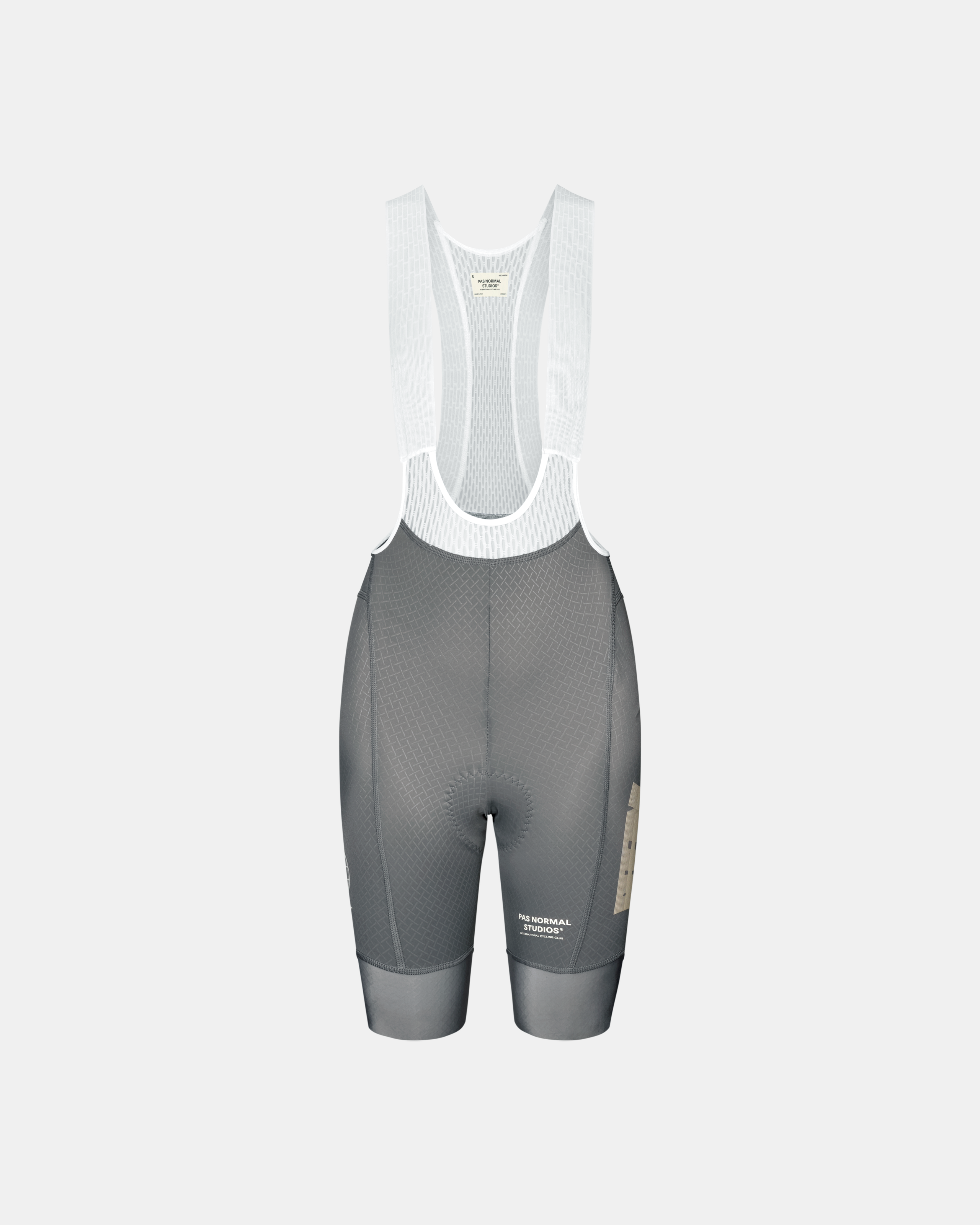 Medium Grey Mechanism women's cycling bib shorts, front flat lay with white mesh straps and tan side panel logo