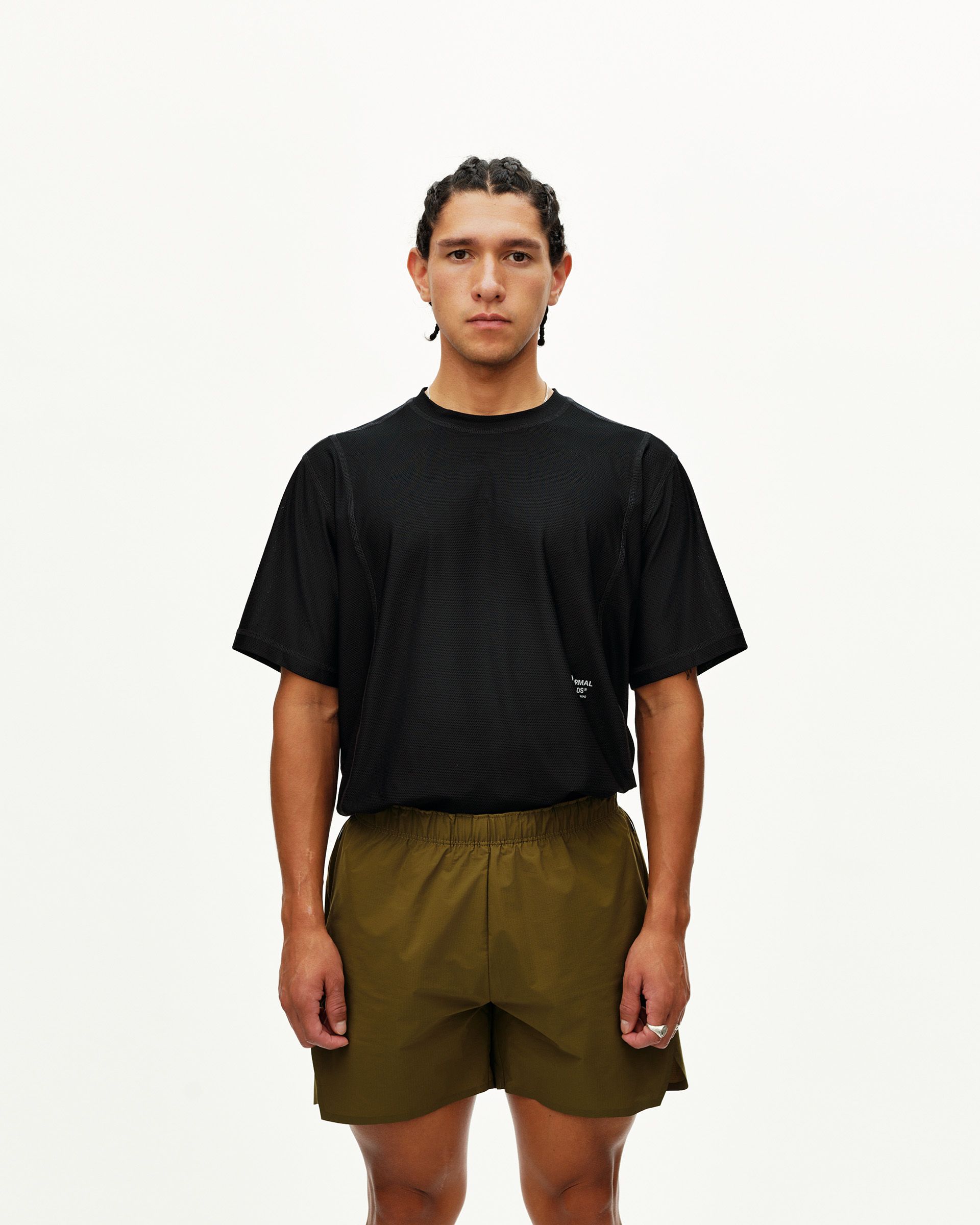 Moss Brown Balance shorts on model, front view with elastic waistband