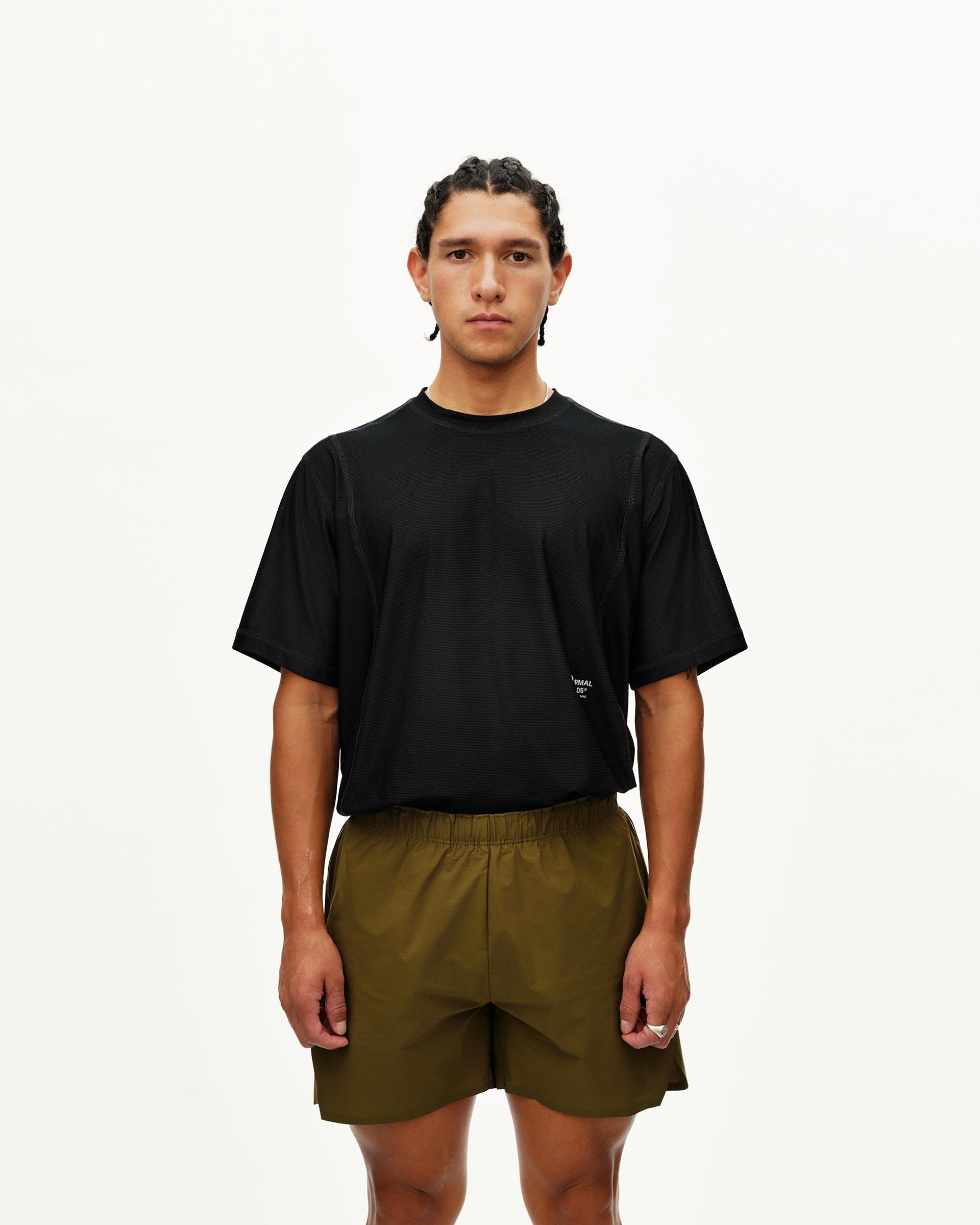 Moss Brown Balance shorts on model, front view with elastic waistband