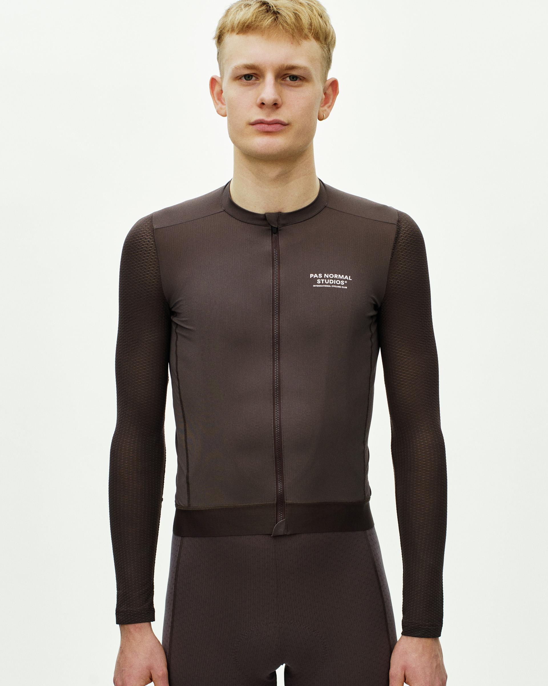 Dark Purple Essential Light long sleeve cycling jersey on model with textured sleeves and white chest logo