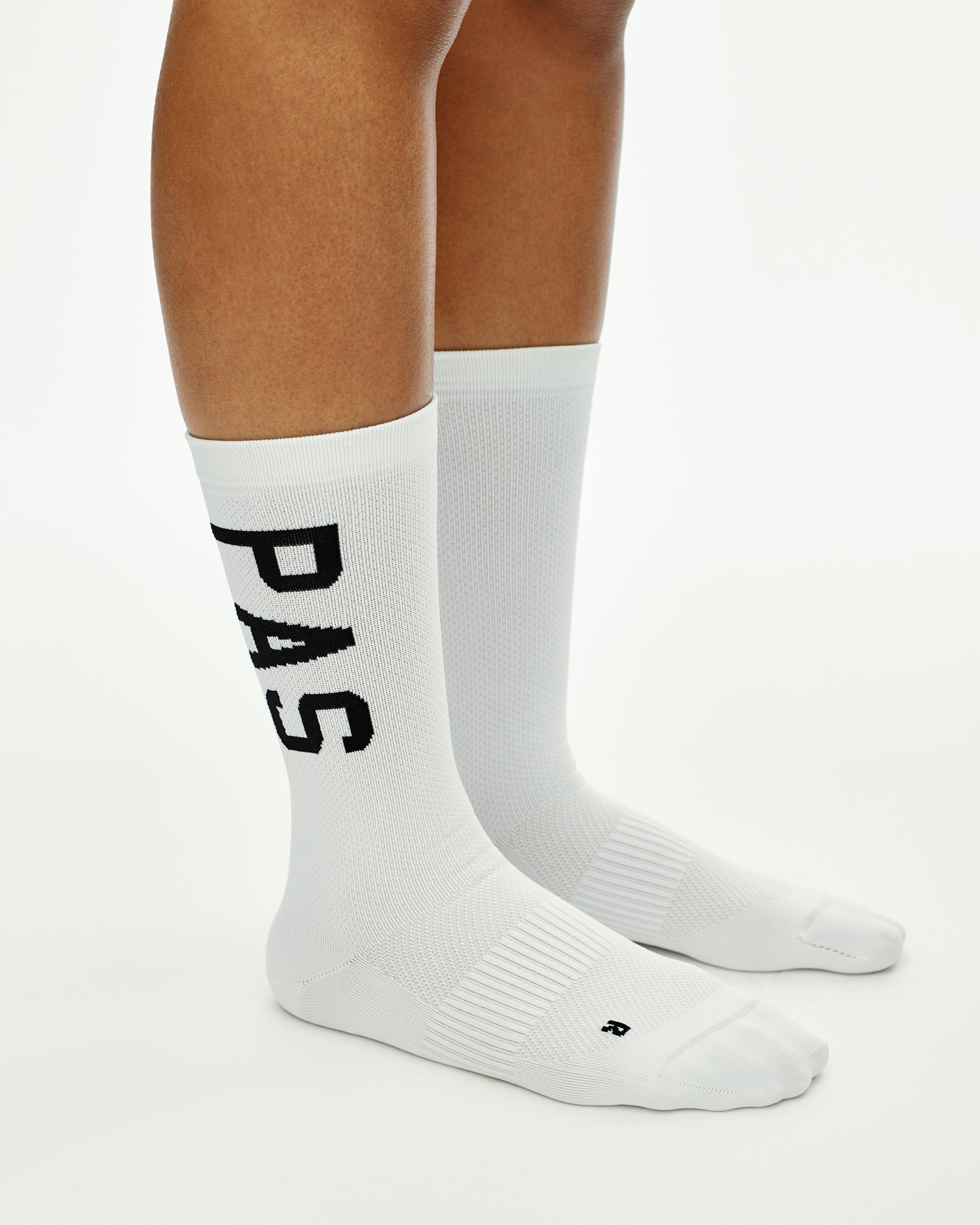 White PAS cycling socks on model with black vertical logo print