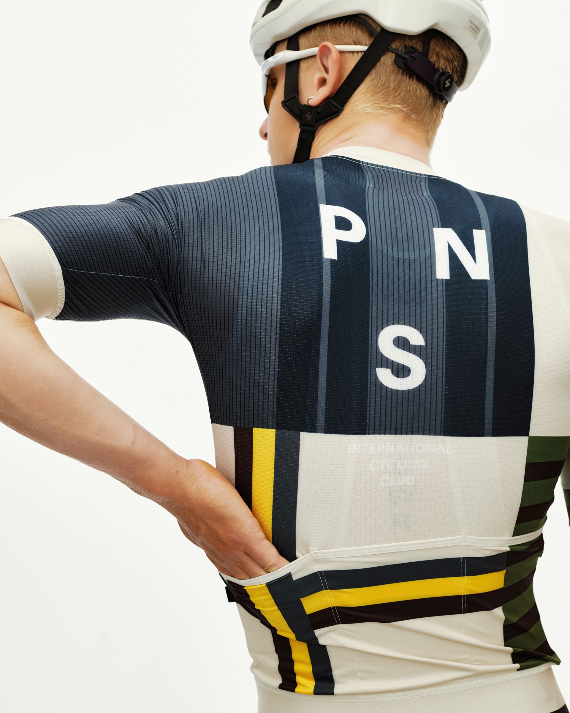 International Sand Mechanism cycling jersey on model, rear view with bold multicolor block stripe print and large back logo